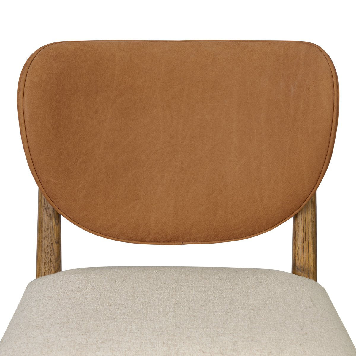 Four Hands Arlow Dining Chair in Nubuck Cognac leather back with natural linen seat on amber oak, close-up detail, view 3