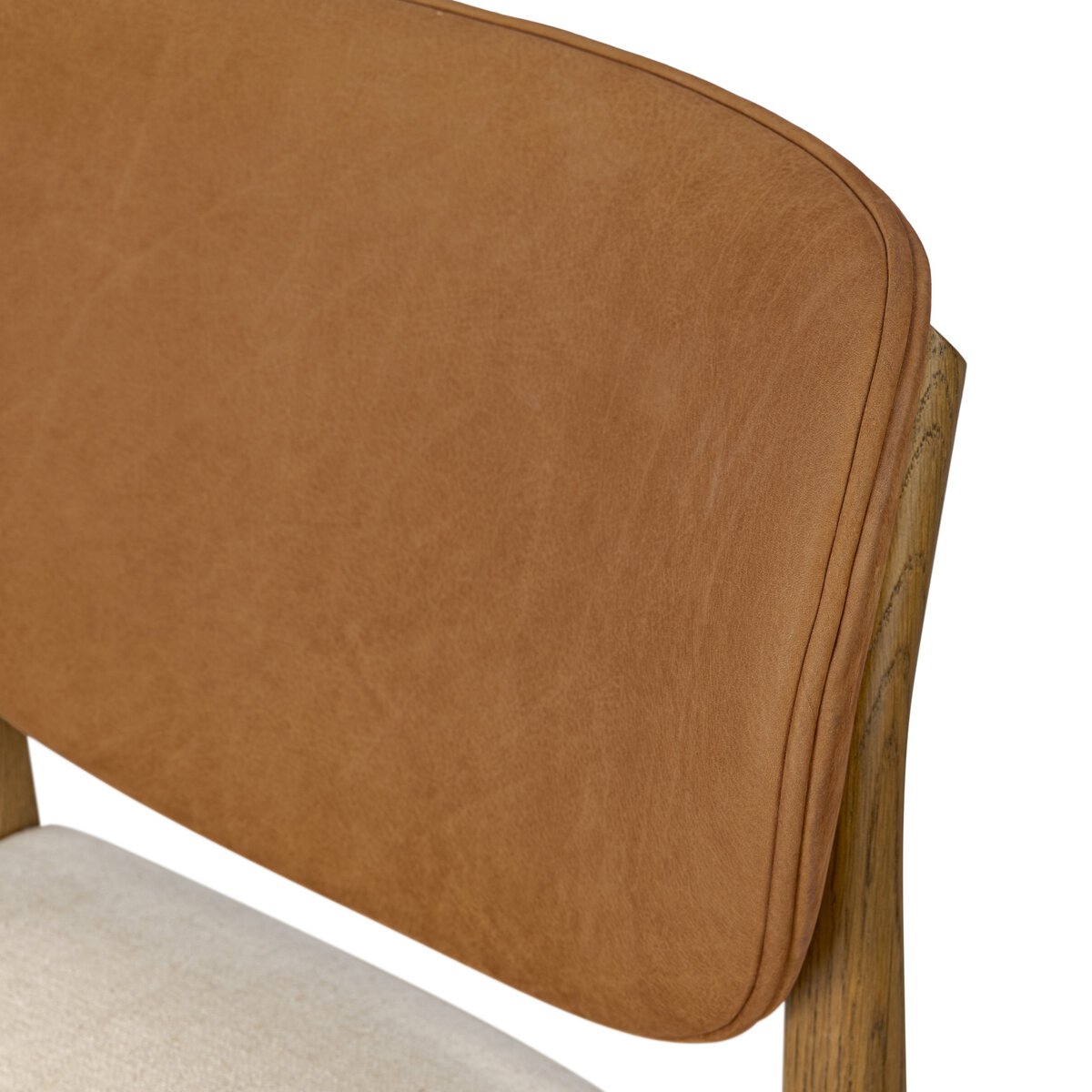 Four Hands Arlow Dining Chair in Nubuck Cognac leather back with natural linen seat on amber oak, close-up detail, view 4