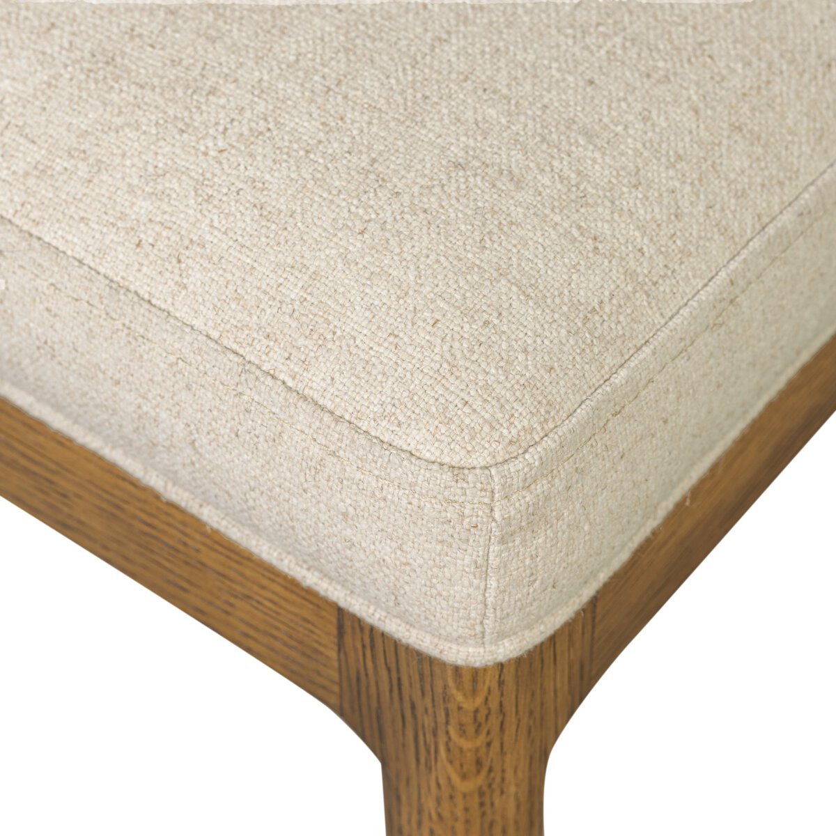 Four Hands Arlow Dining Chair in Nubuck Cognac leather back with natural linen seat on amber oak, close-up detail, view 5