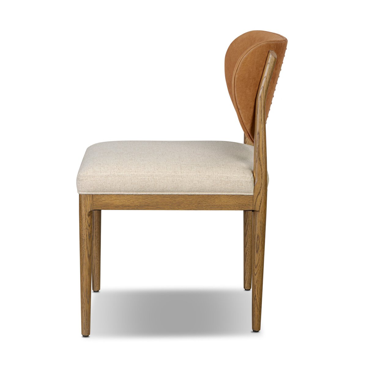 Four Hands Arlow Dining Chair in Nubuck Cognac leather back with natural linen seat on amber oak, side profile view