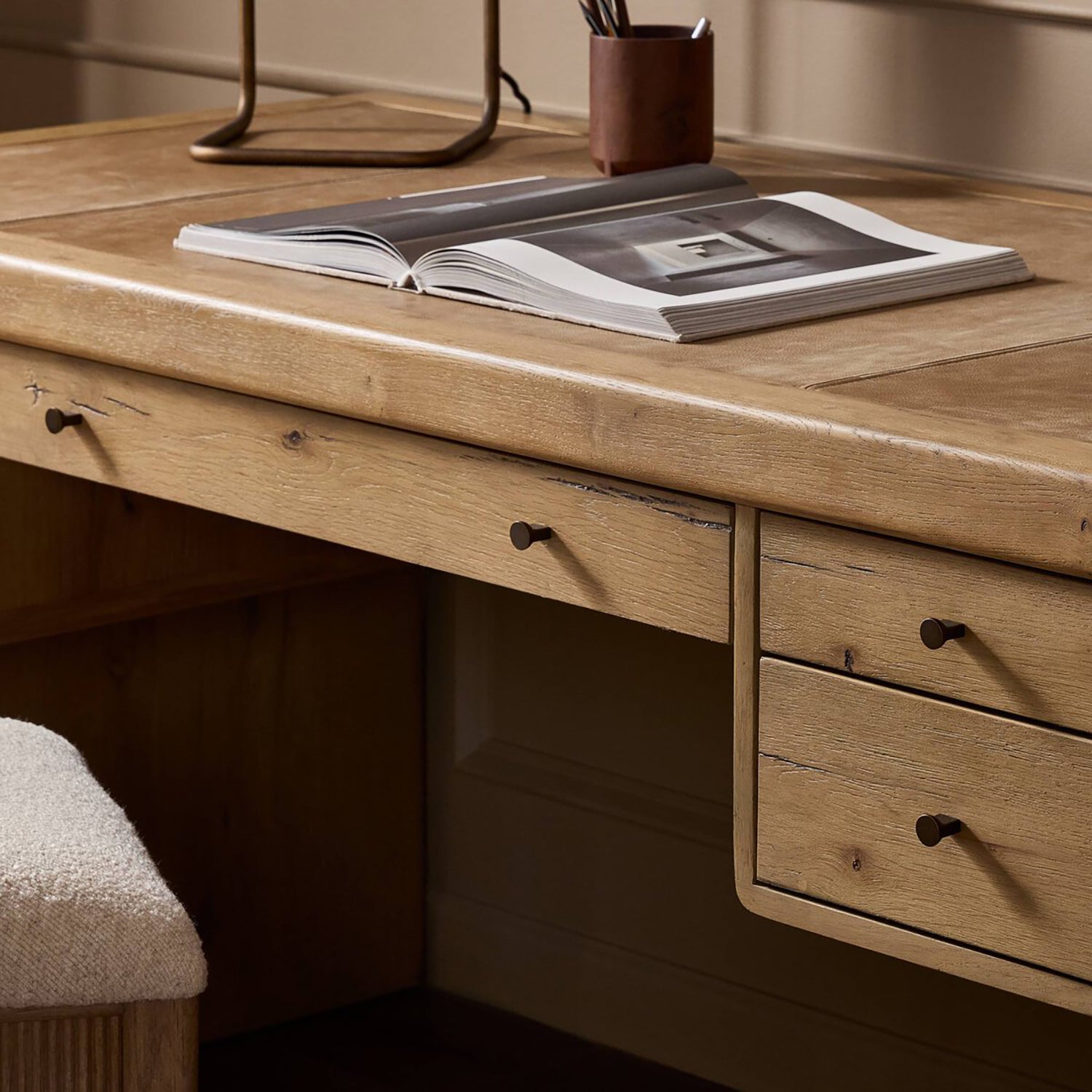 Four Hands Nico Desk in natural oak with leather inlay top, close-up detail of leather inlay and oak grain, view 1