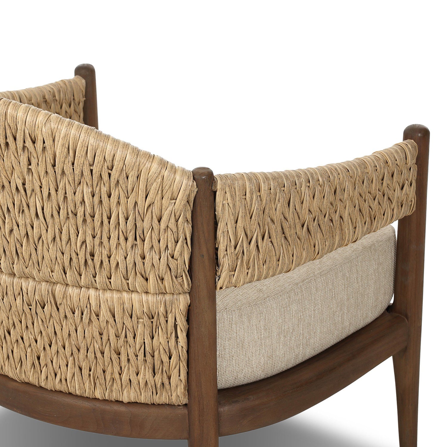 Four Hands Atwood Outdoor Chair in teak with coastal weave and beige cushion, close-up detail, view 1