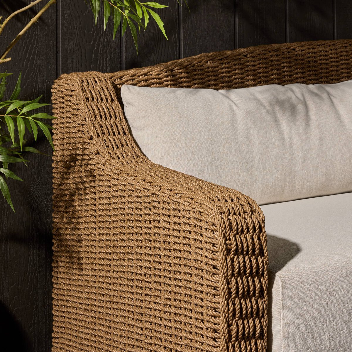 Four Hands Marina Outdoor Sofa in twisted umber faux rattan with Alessi Linen cushions, close-up detail of rattan weave, view 1