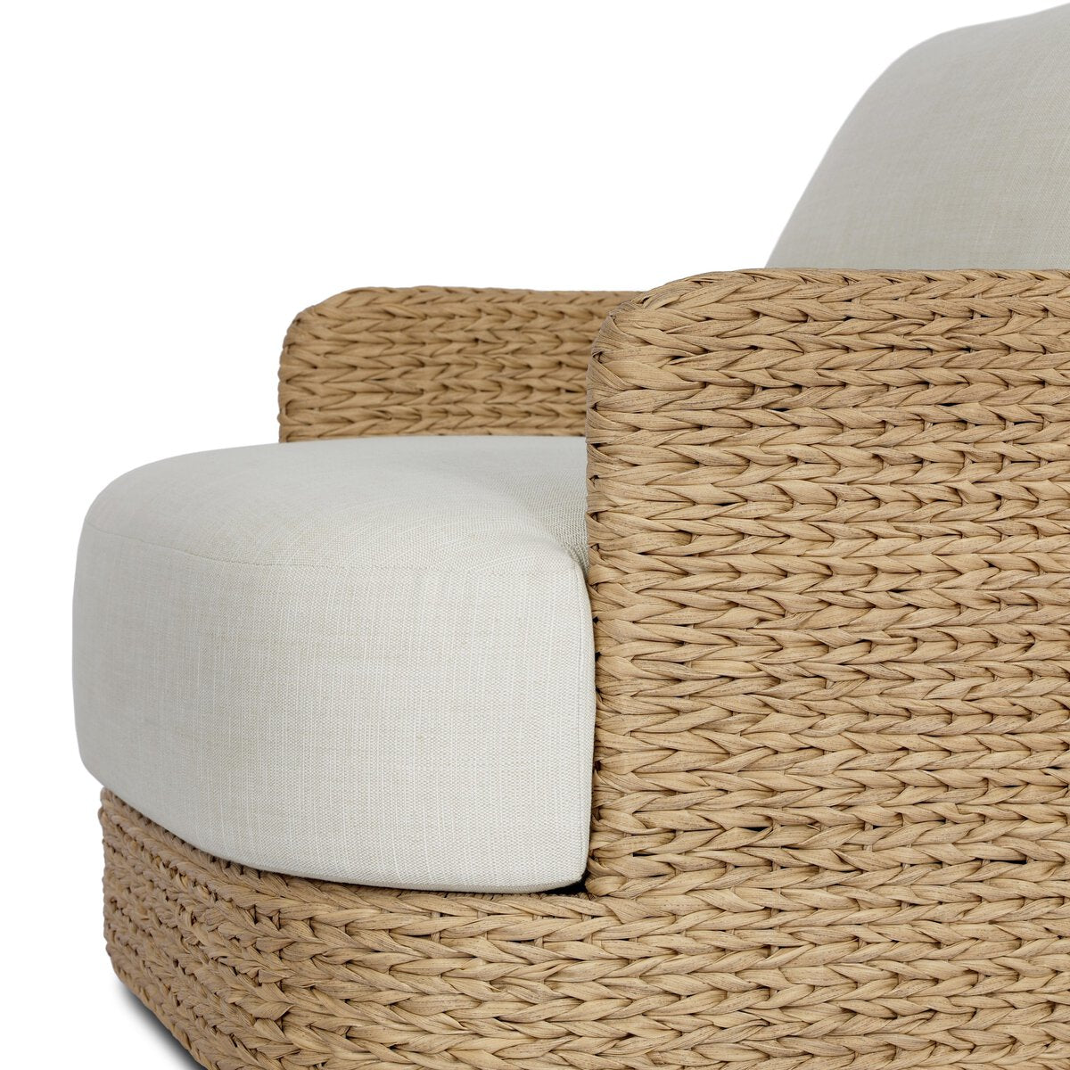 Four Hands Caney Outdoor Swivel Chair in coastal weave with cream cushion, close-up detail, view 3