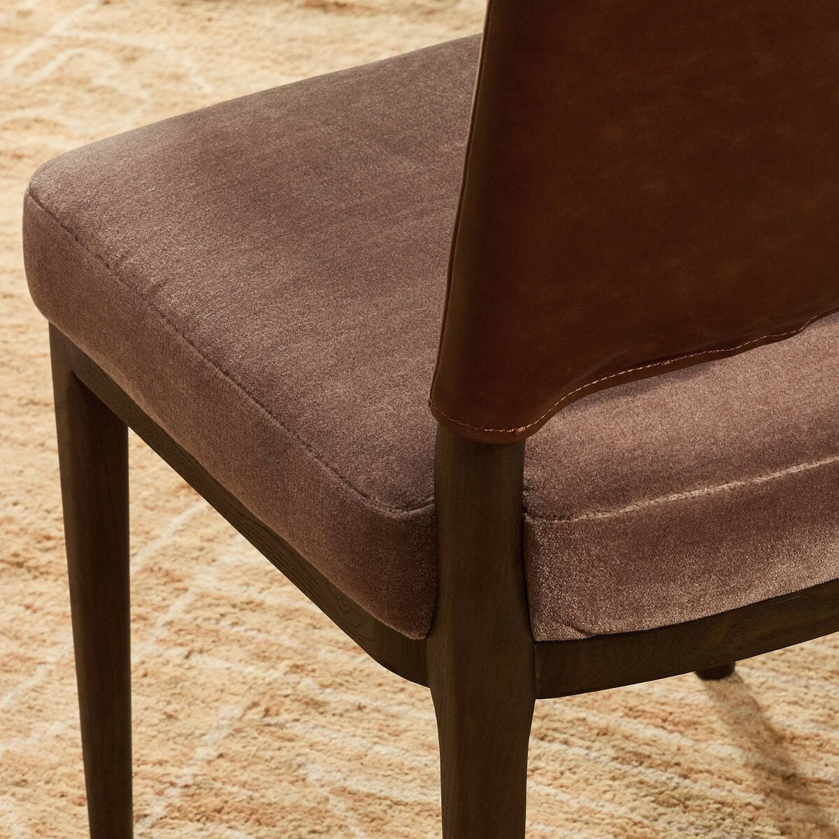 Four Hands Ryver Monte Mushroom Dining Chair Set of 2 with mahogany leather back on burnt ash, close-up detail of velvet seat, view 3
