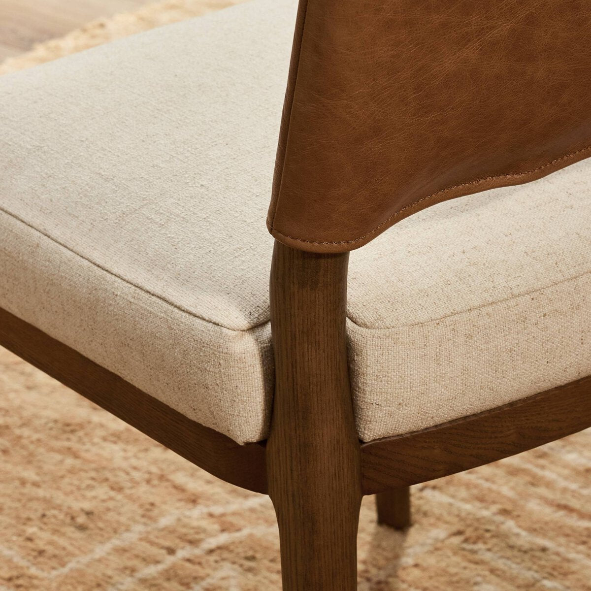 Four Hands Ryver Antwerp Natural Dining Chair Set of 2 with leather back on toasted ash, close-up detail of fabric seat, view 1