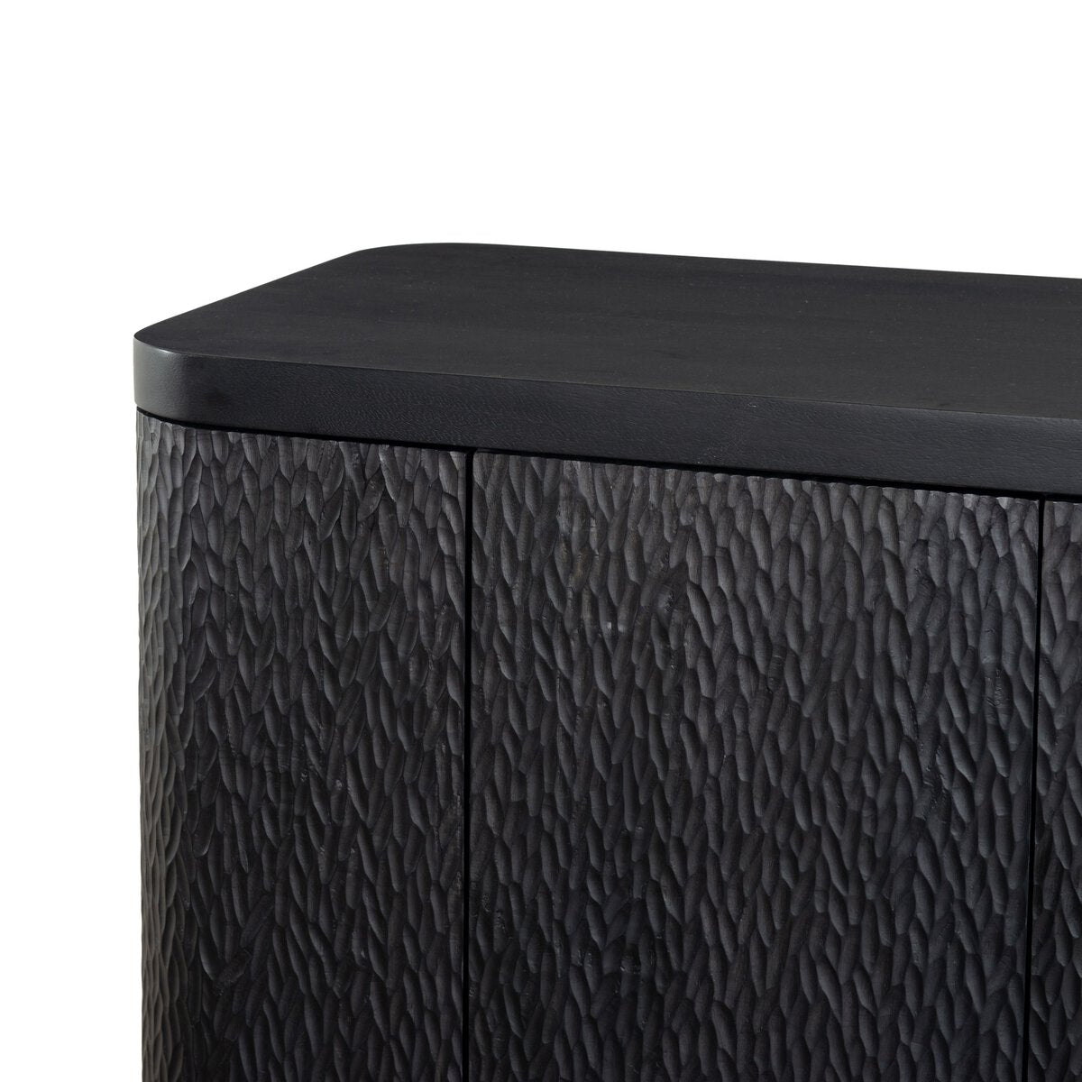 Four Hands Shevall Sideboard in carved black mango with cylinder legs, close-up detail of carved door front, view 2
