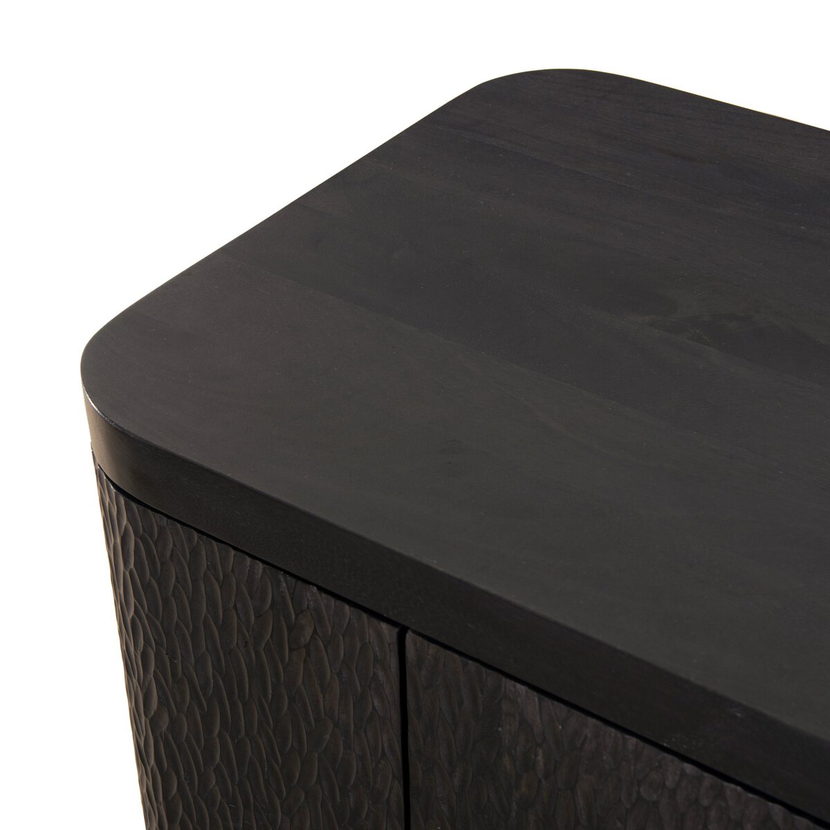 Four Hands Shevall Sideboard in carved black mango with cylinder legs, close-up detail of carved door front, view 3
