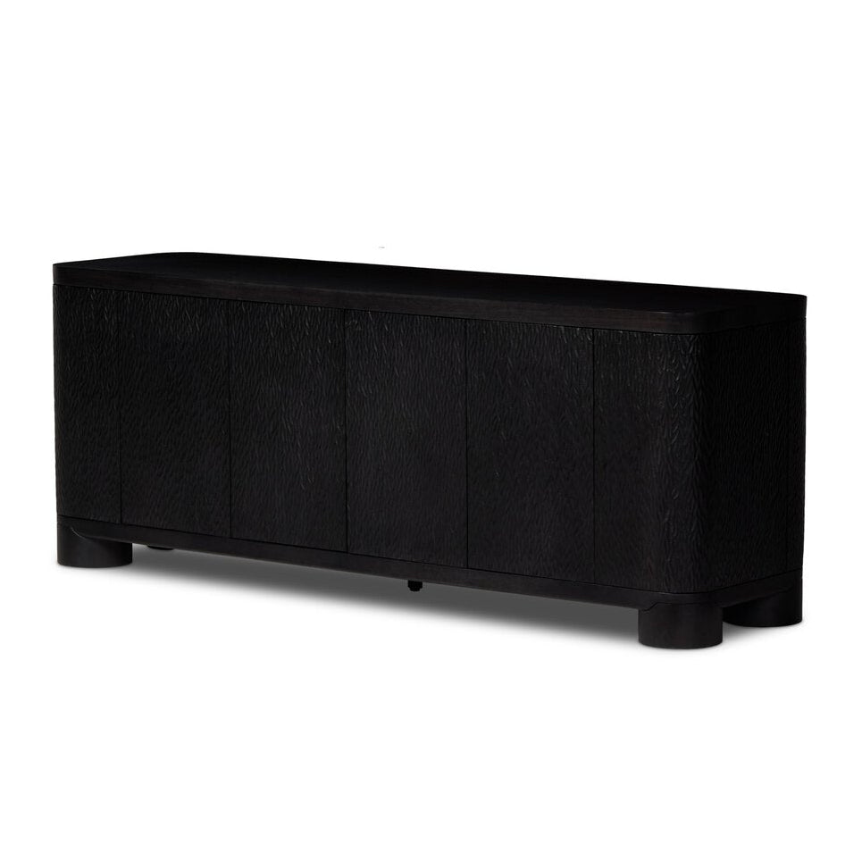 Four Hands Shevall Sideboard in carved black mango with cylinder legs, primary product view