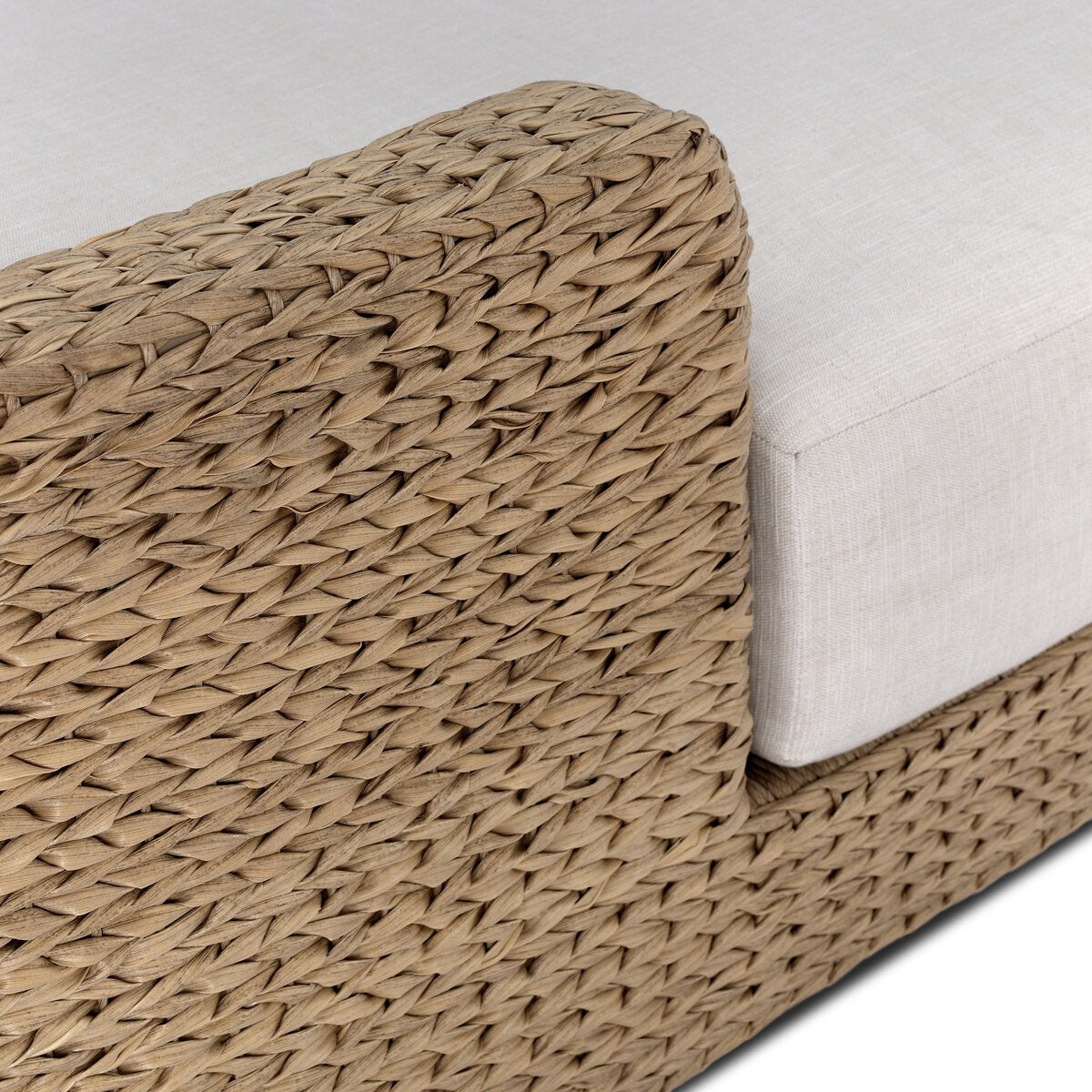Four Hands Caney Outdoor Double Chaise in coastal weave with cream cushion, close-up detail, view 2