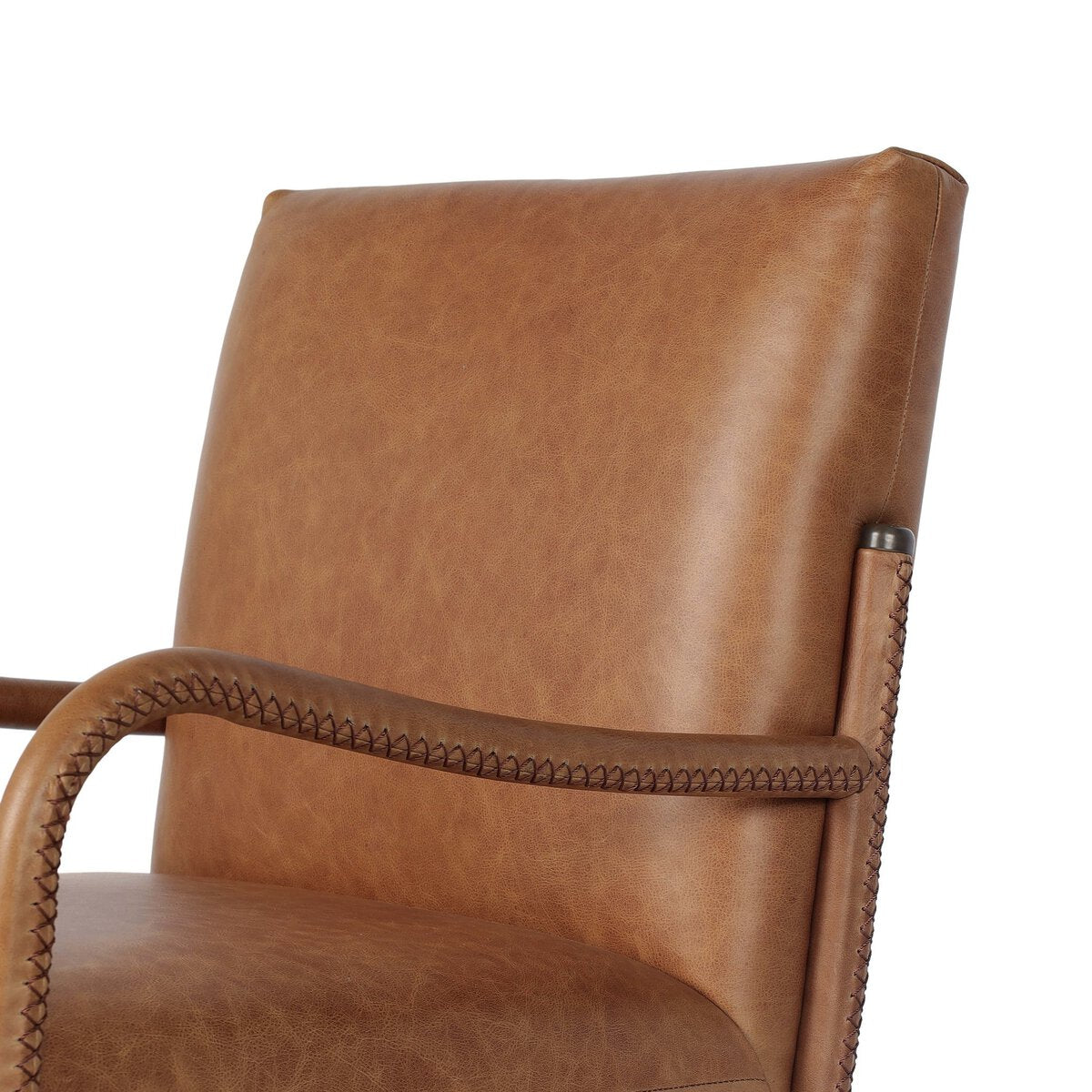 Four Hands Quill Dining Armchair in Chaps Saddle leather with leather-wrapped iron legs, close-up detail of leather, view 3