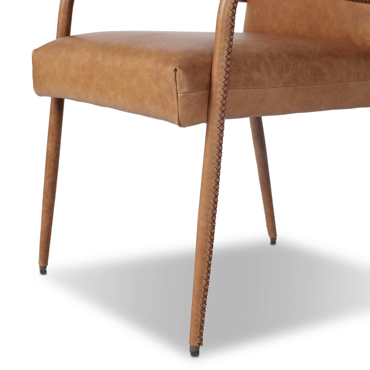 Four Hands Quill Dining Armchair in Chaps Saddle leather with leather-wrapped iron legs, close-up detail of leather, view 6