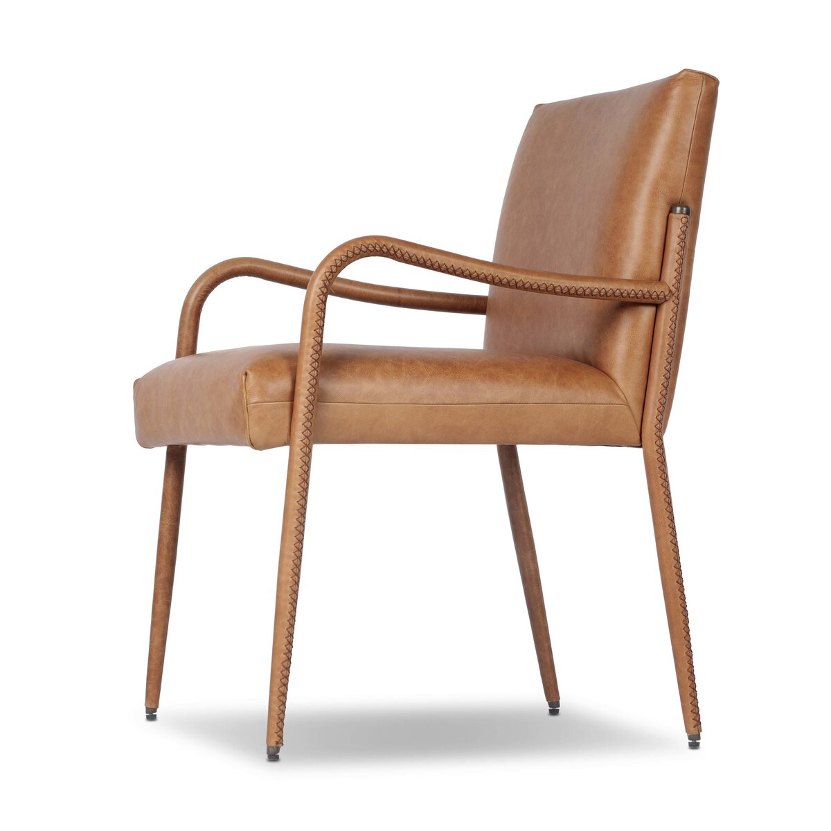 Four Hands Quill Dining Armchair in Chaps Saddle leather with leather-wrapped iron legs, close-up detail of leather, view 2