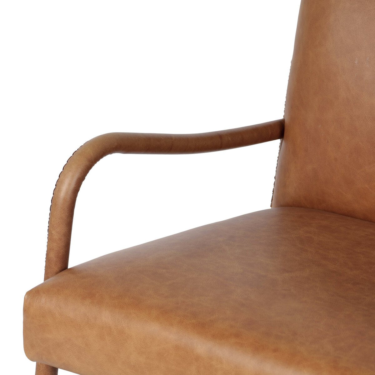 Four Hands Quill Dining Armchair in Chaps Saddle leather with leather-wrapped iron legs, close-up detail of leather, view 5