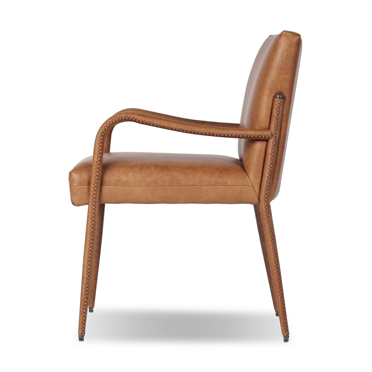 Four Hands Quill Dining Armchair in Chaps Saddle leather with leather-wrapped iron legs, side profile view