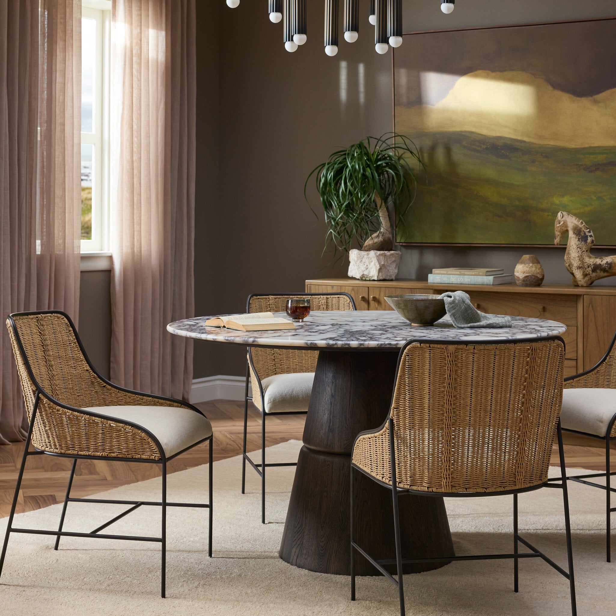 Four Hands Lino Calacatta Viola Marble Dining Table styled in a room setting