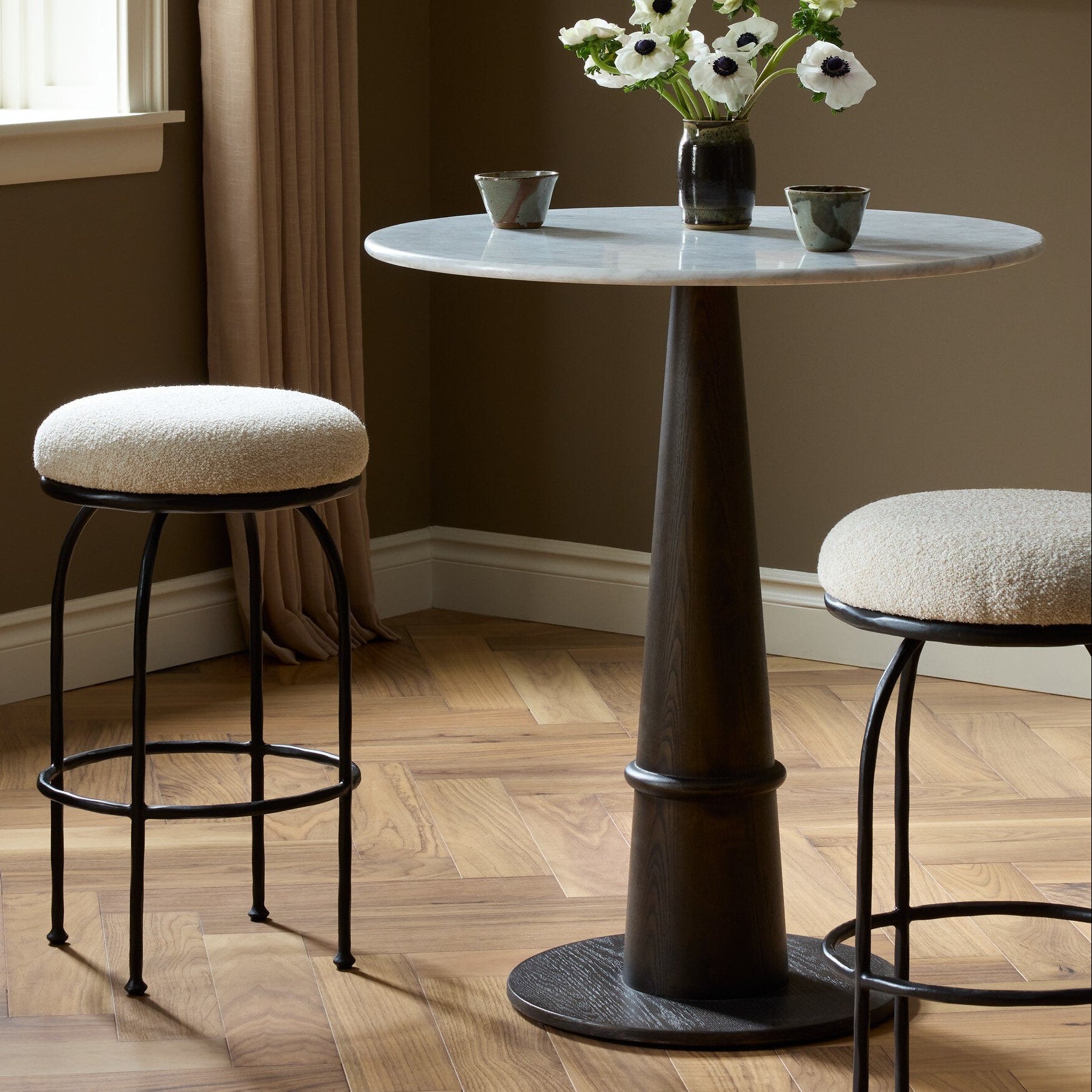 Four Hands Larisa Yuma Cream Swivel Bar Stool styled in a room setting