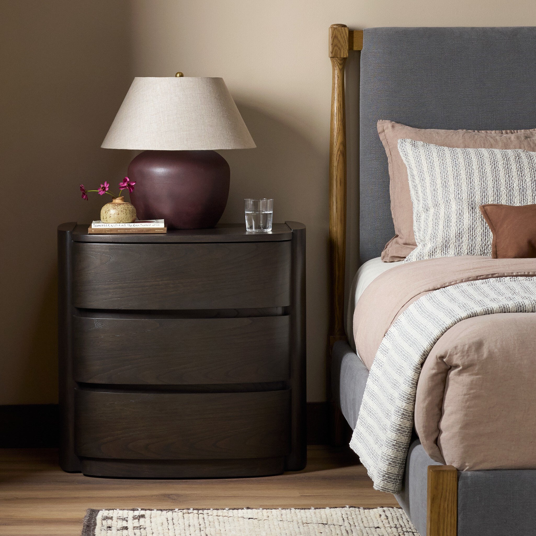 Four Hands Greer Smoked Black Sungkai Nightstand — in a styled room setting