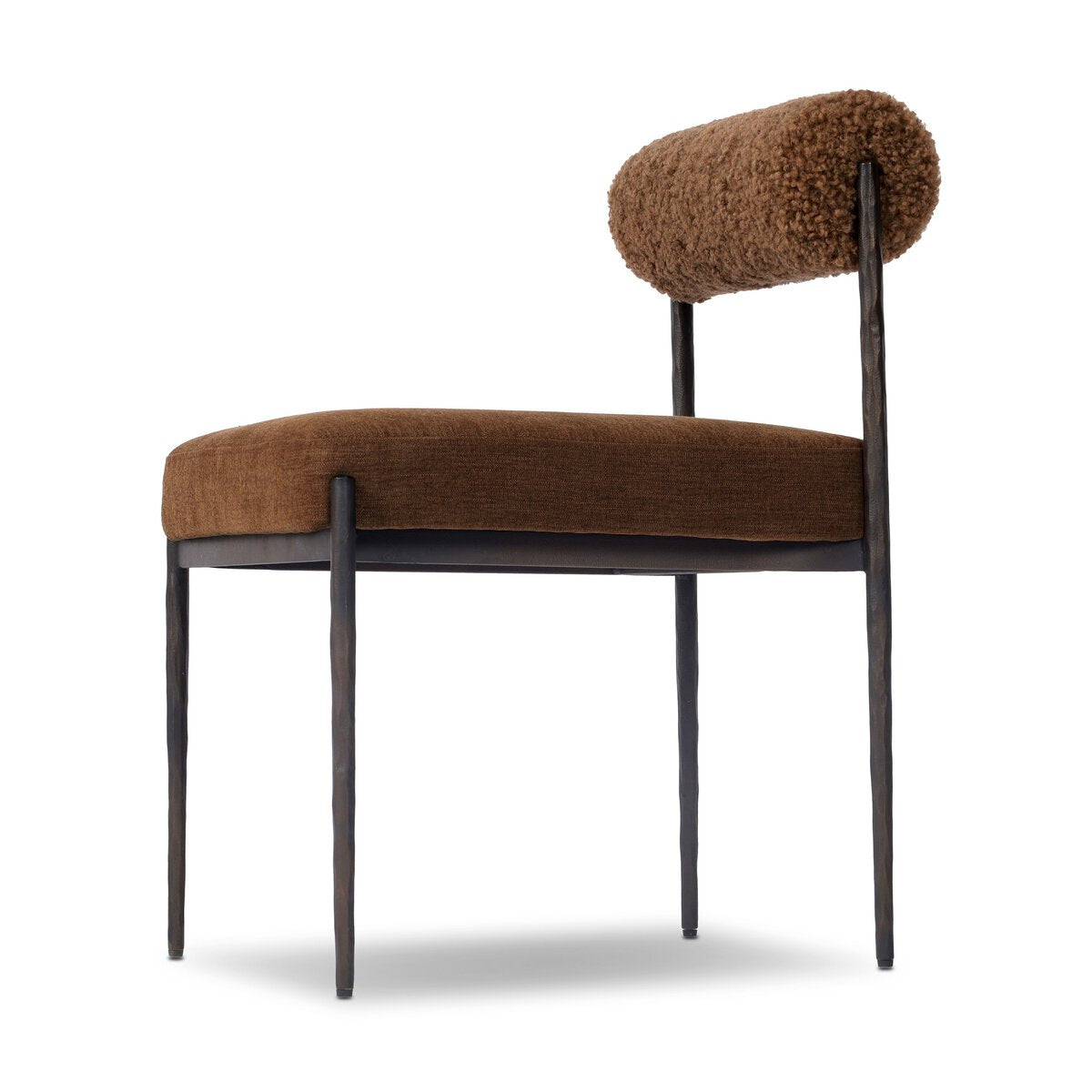 Four Hands Jazelle Laughlin Ochre Metal Dining Chair with amber shearling seat, close-up detail of iron frame