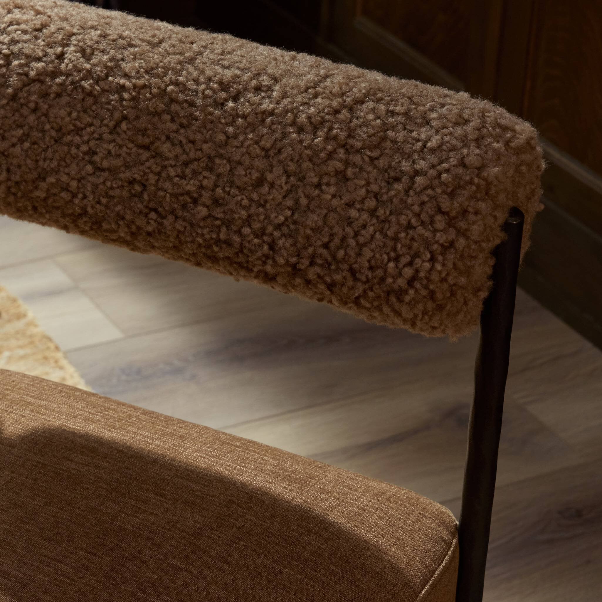 Four Hands Jazelle Laughlin Ochre Metal Dining Chair with amber shearling seat, close-up detail of shearling, view 1