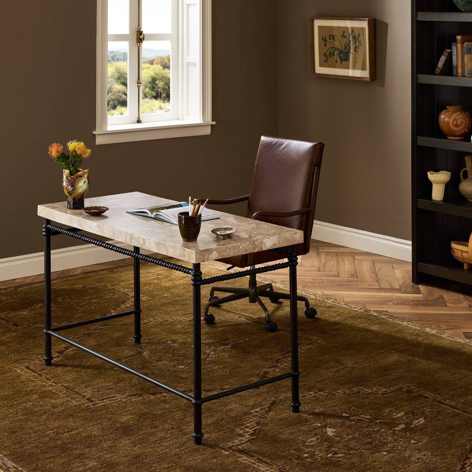 Four Hands Cassia Textured Dark Bronze Desk styled in a room setting