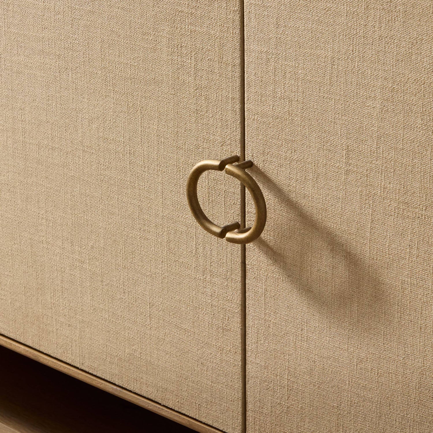 Four Hands Kiran Media Console in sandy oak and beige painted linen, close-up detail of iron hardware, view 3