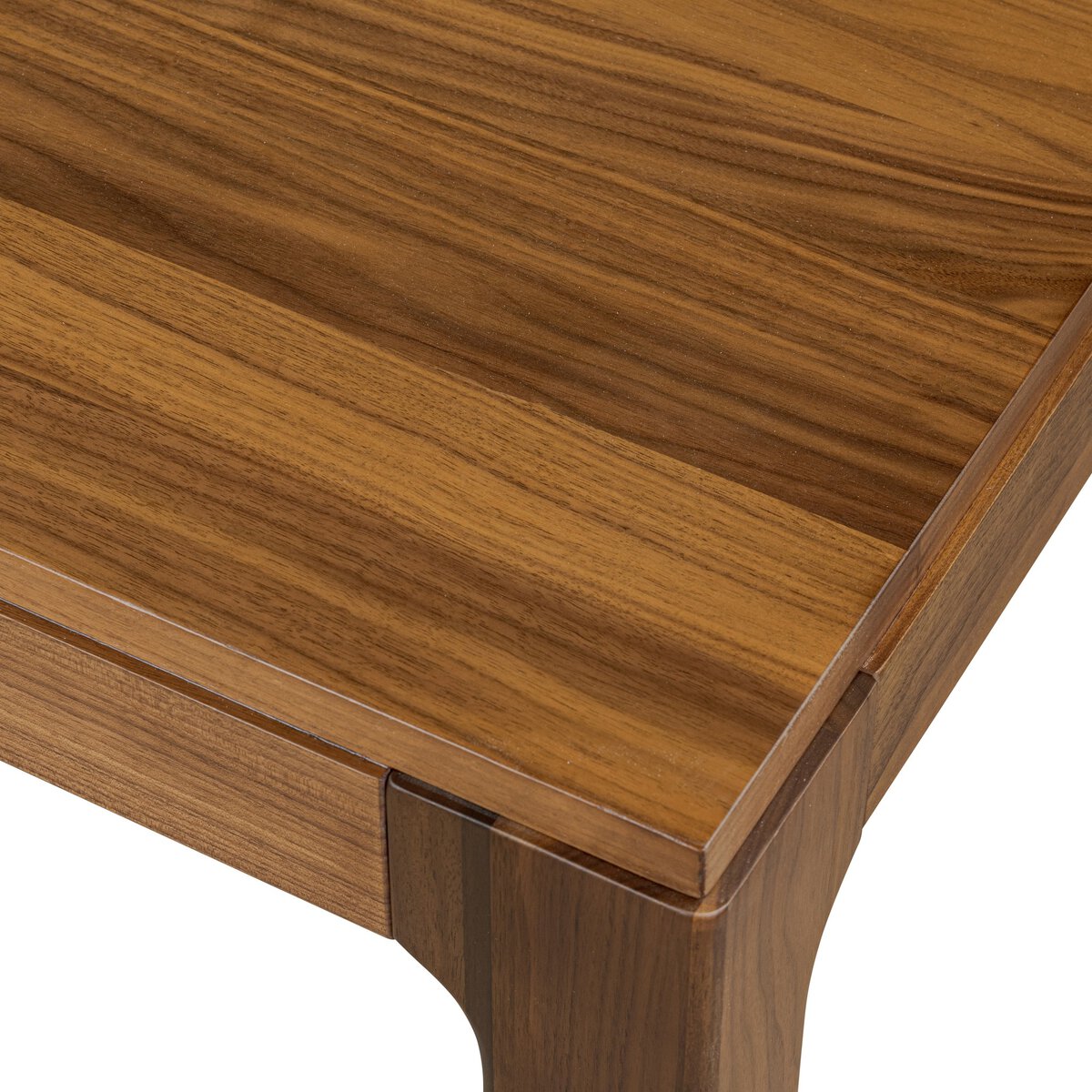 Four Hands Arturo 78in Dining Table in natural walnut, close-up detail of rounded legs, view 1