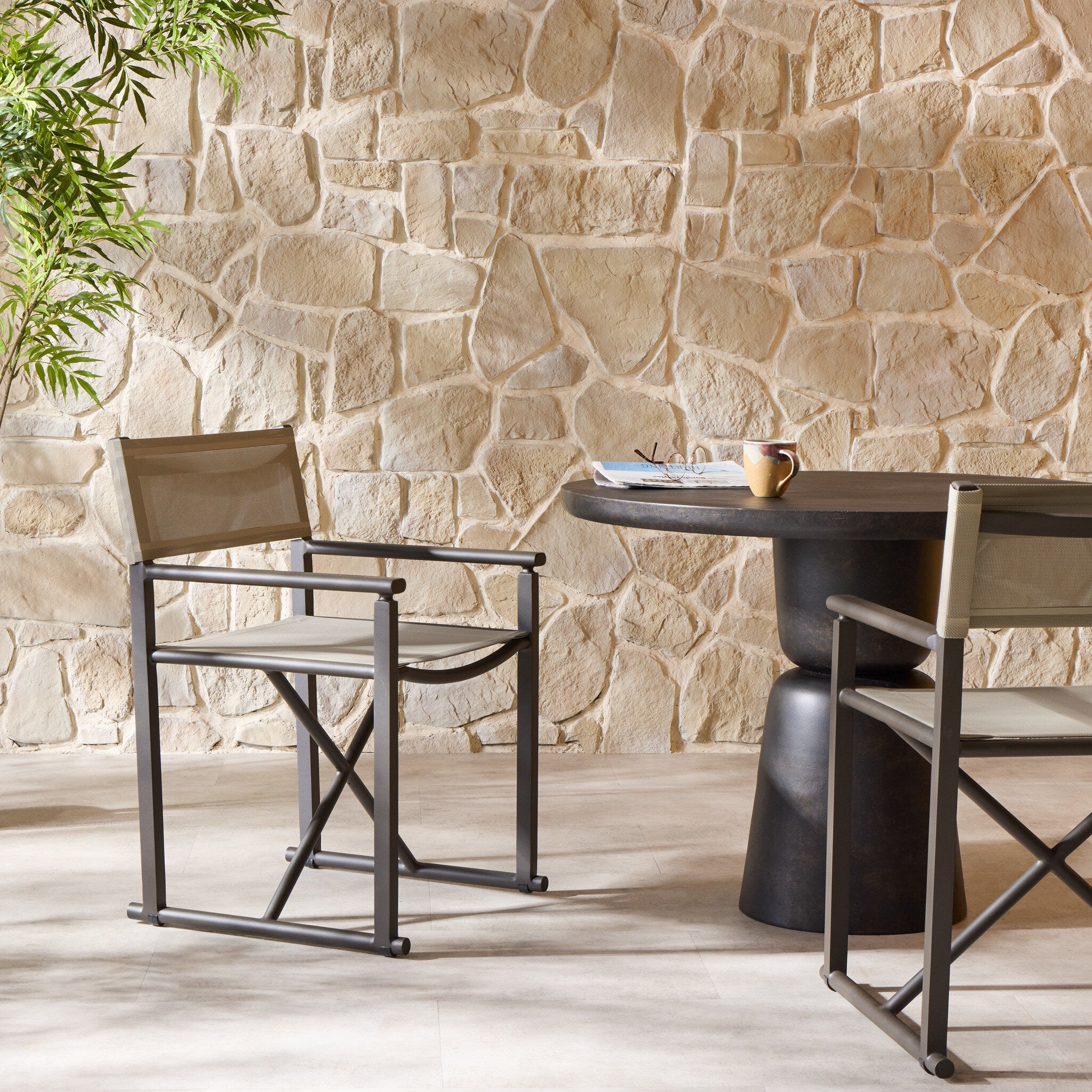 Four Hands Brisco Taupe Mesh Outdoor Dining Chair in a styled room setting