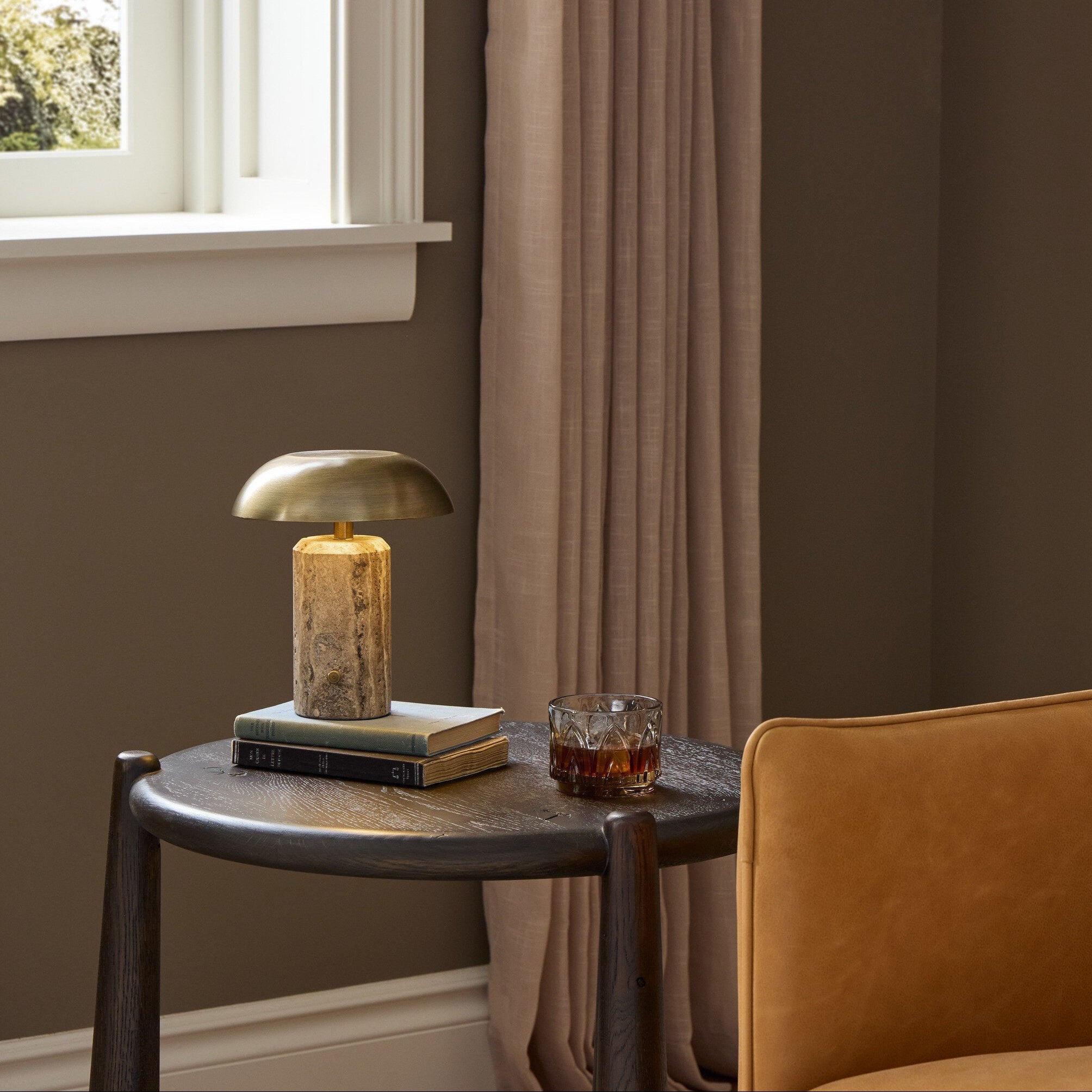 Four Hands Zana Grey Stripe Travertine Cordless Table Lamp in a styled room setting