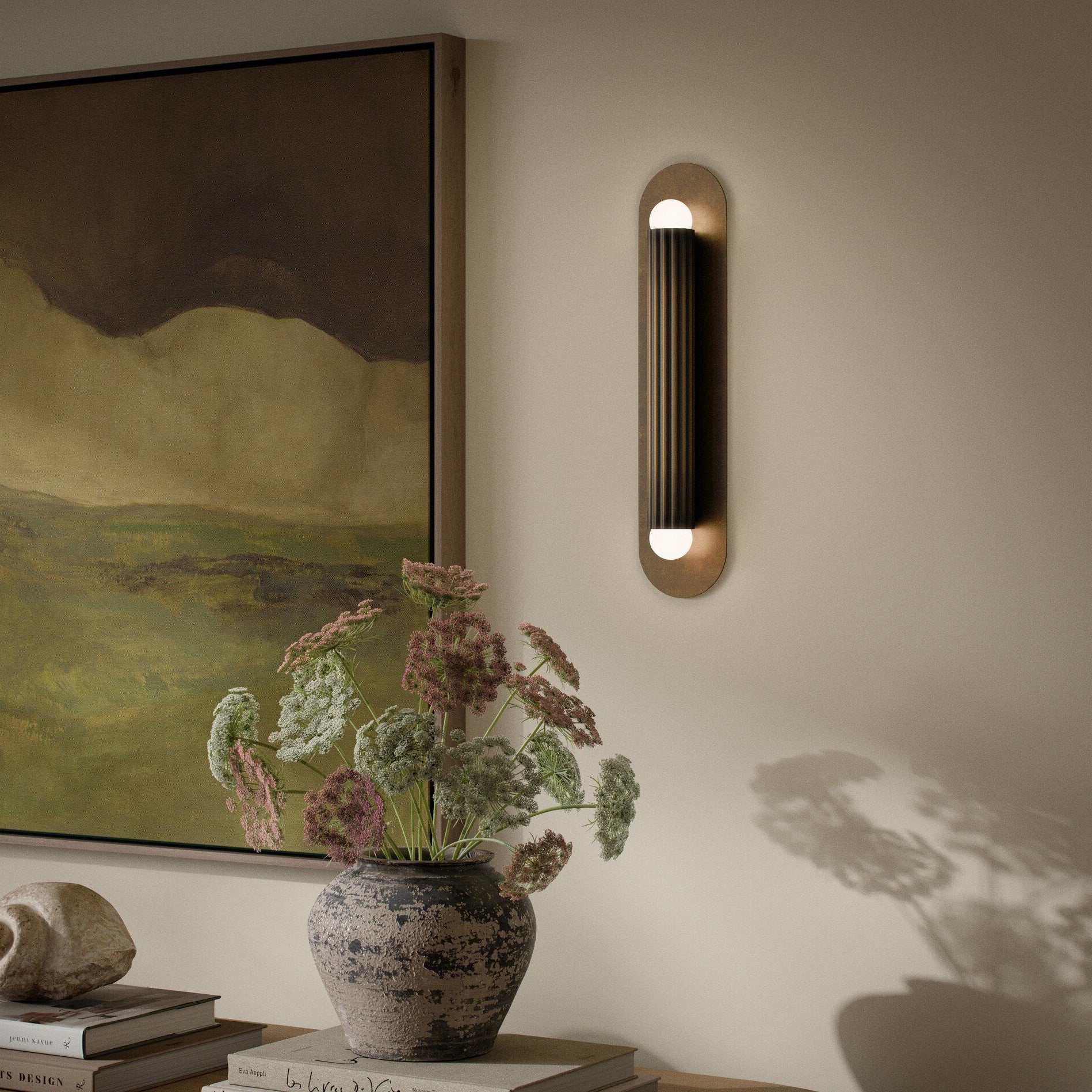 Four Hands Vesta Heritage Bronze Brass Wall Sconce styled in a room setting