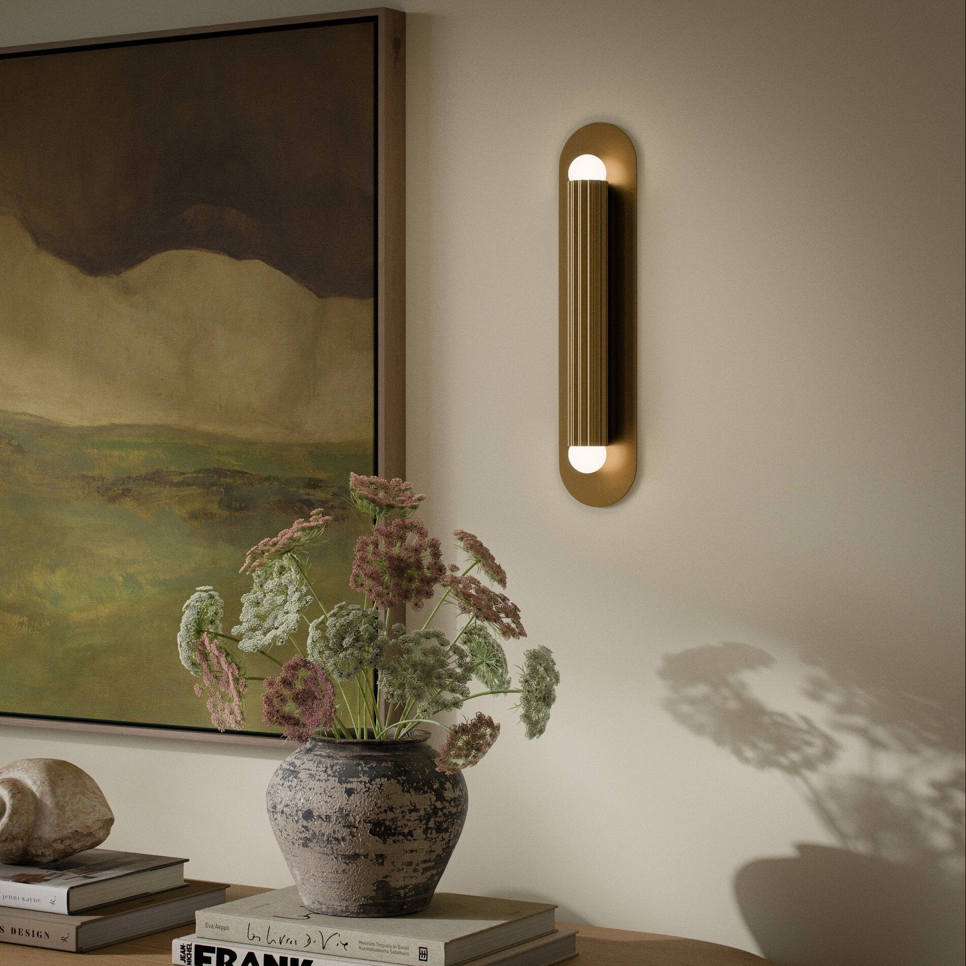 Four Hands Vesta Burnished Brass Wall Sconce styled in a room setting