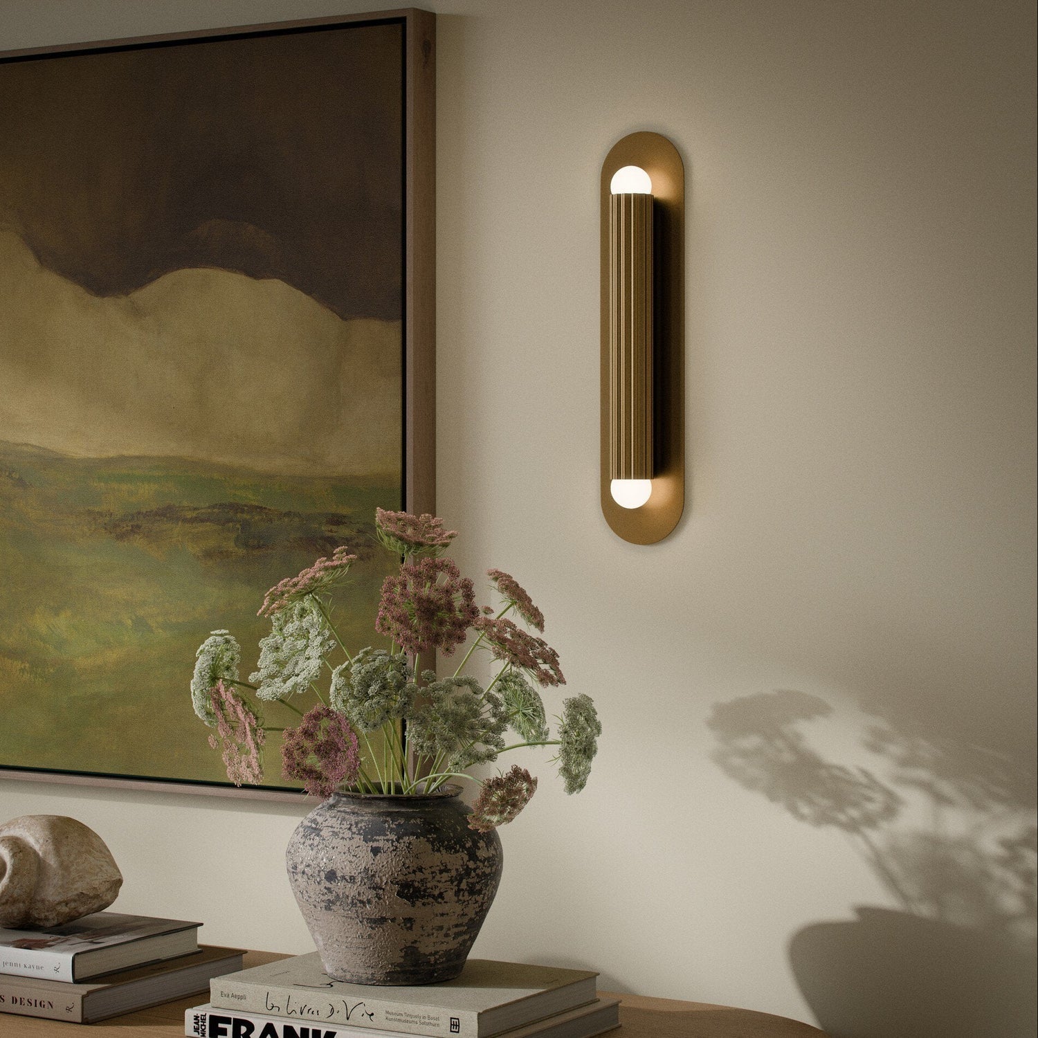 Four Hands Vesta Burnished Brass Wall Sconce styled in a room setting