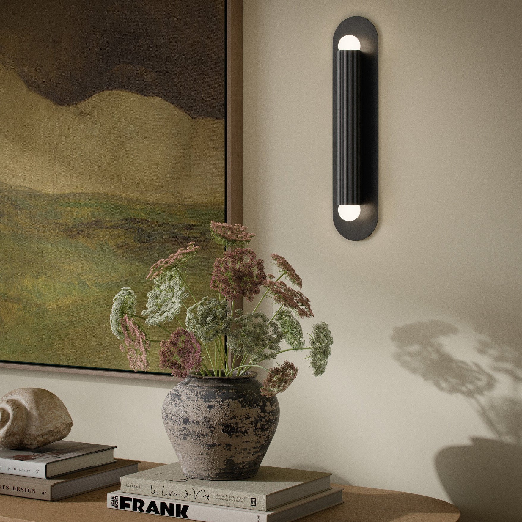 Four Hands Vesta Black Gunmetal Wall Sconce styled in a room setting