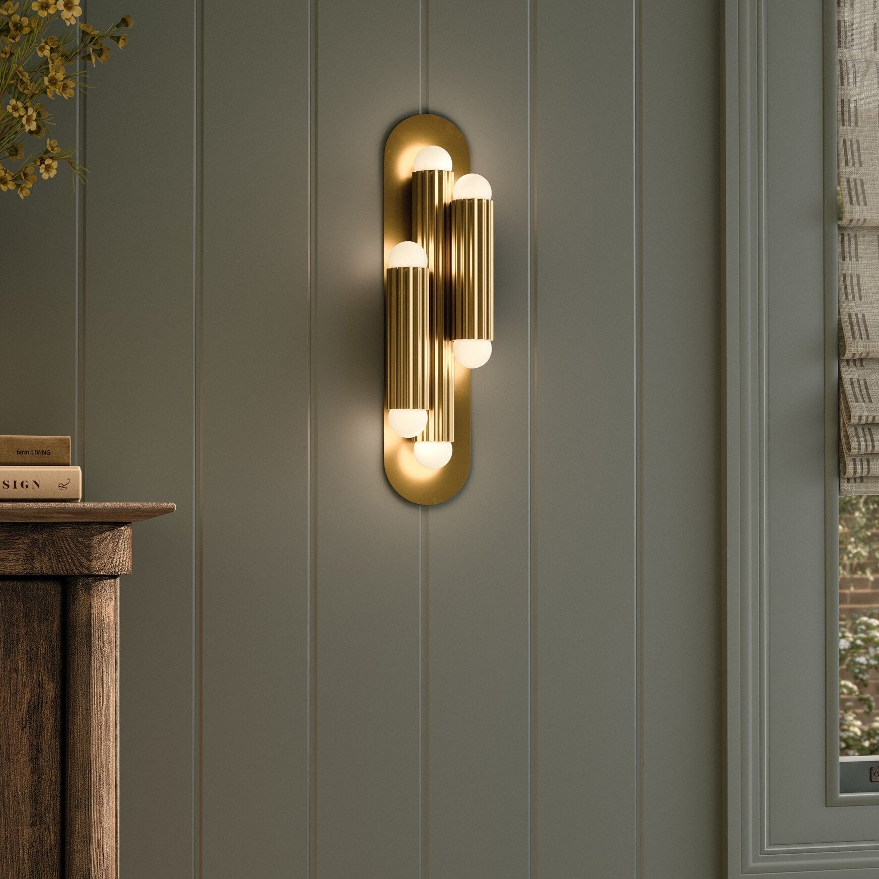 Four Hands Vesta Burnished Brass Triple Wall Sconce styled in a room setting