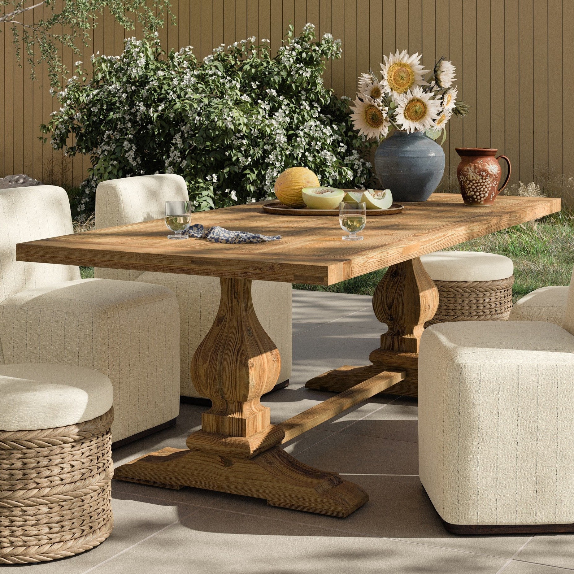 Four Hands Novell Reclaimed Natural Outdoor Dining Table styled in a room setting