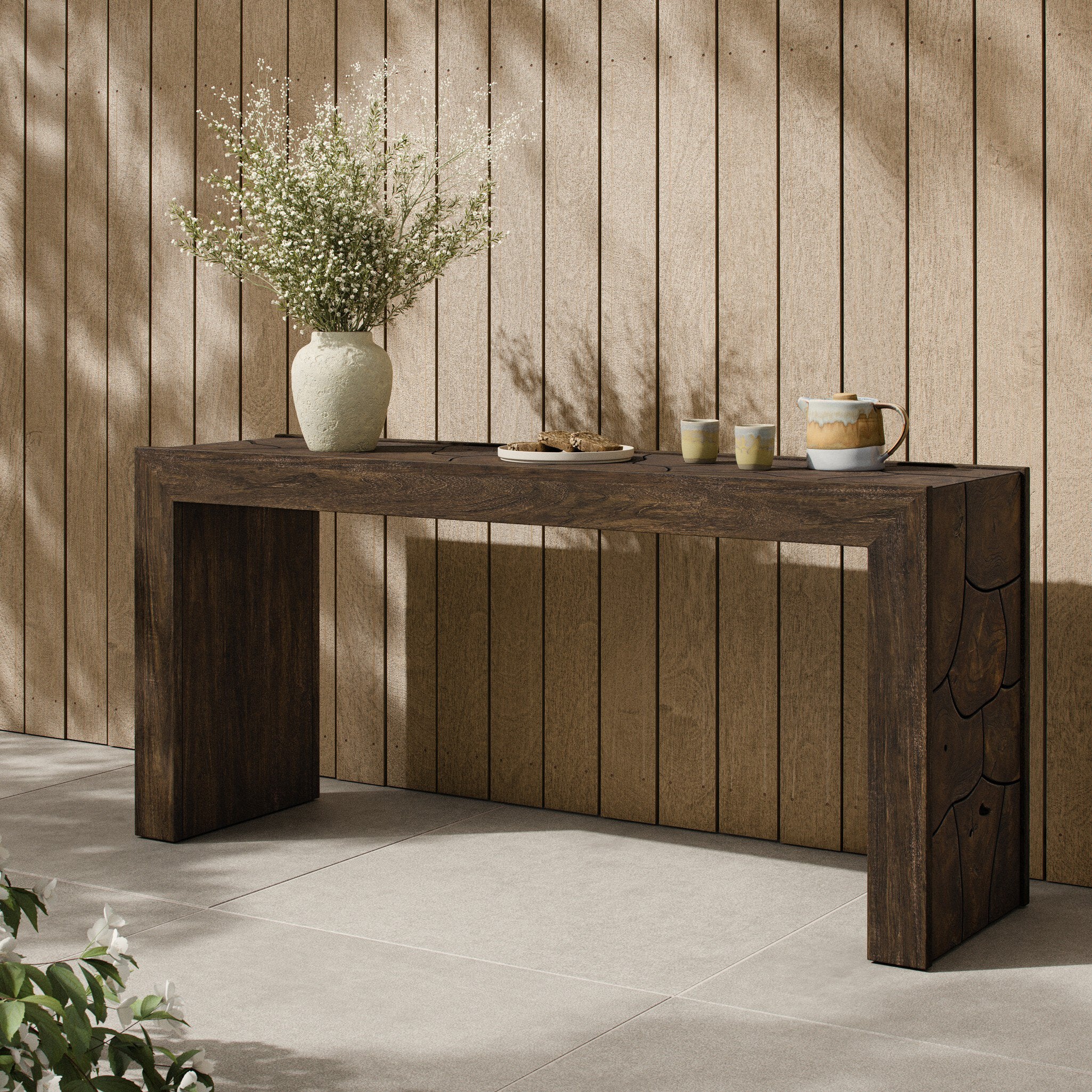 Four Hands Ridge Saddle Brown-Teak Root Outdoor Console Table styled in a room setting