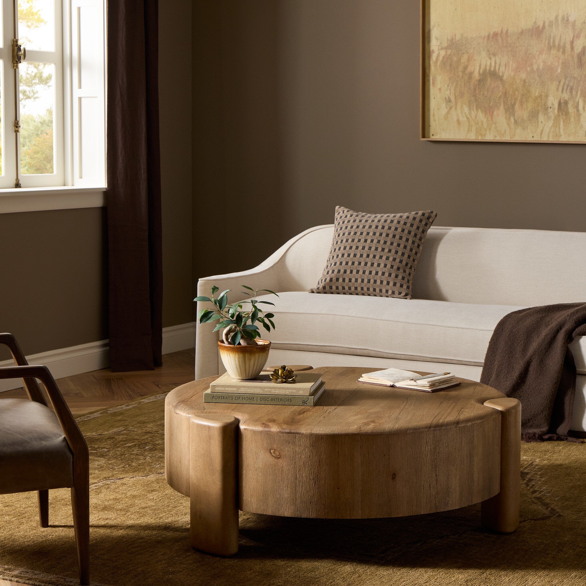 Four Hands Toman Rustic Oak Coffee Table styled in a room setting