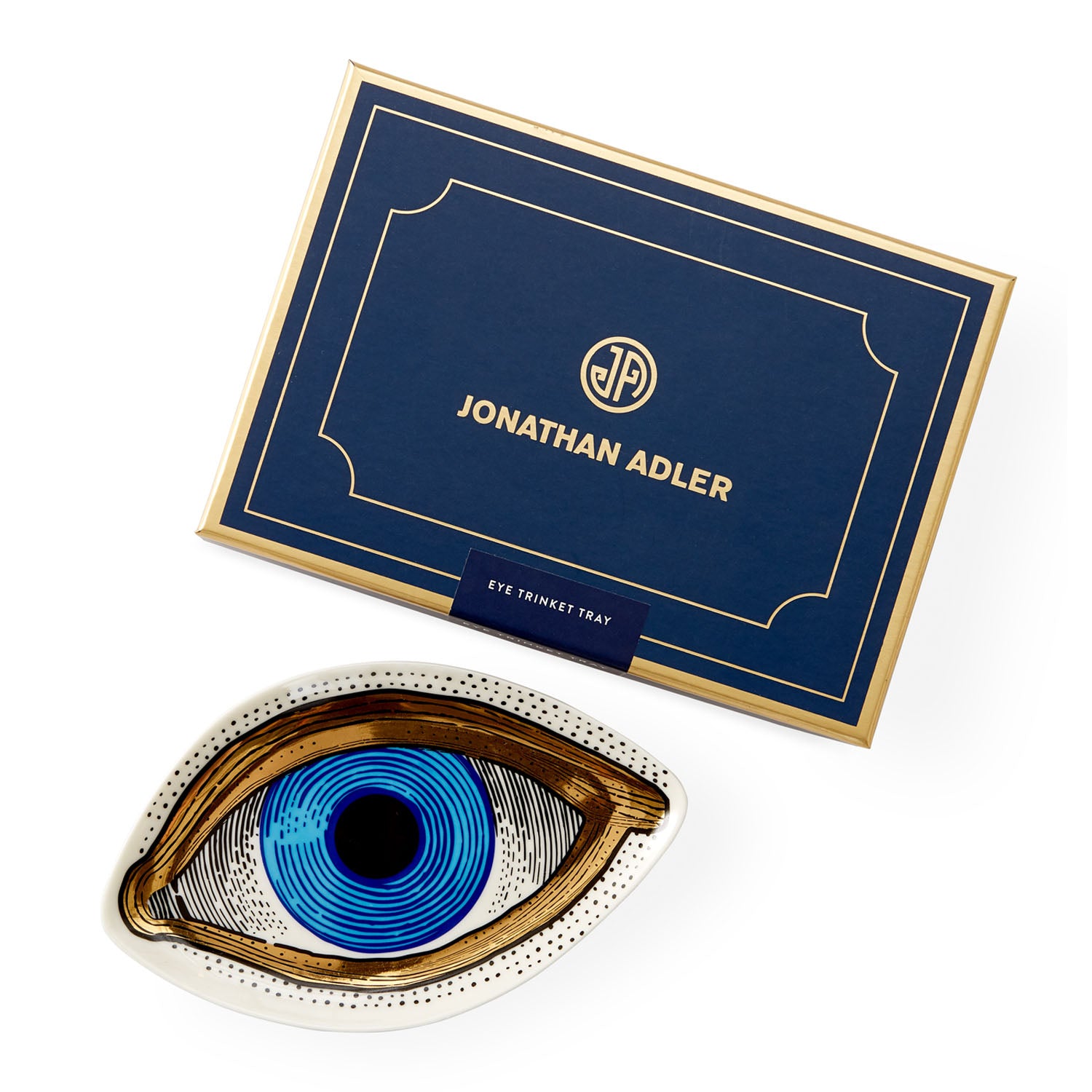 Jonathan Adler Eye Trinket Tray in baby blue porcelain lined in gold styled in a room