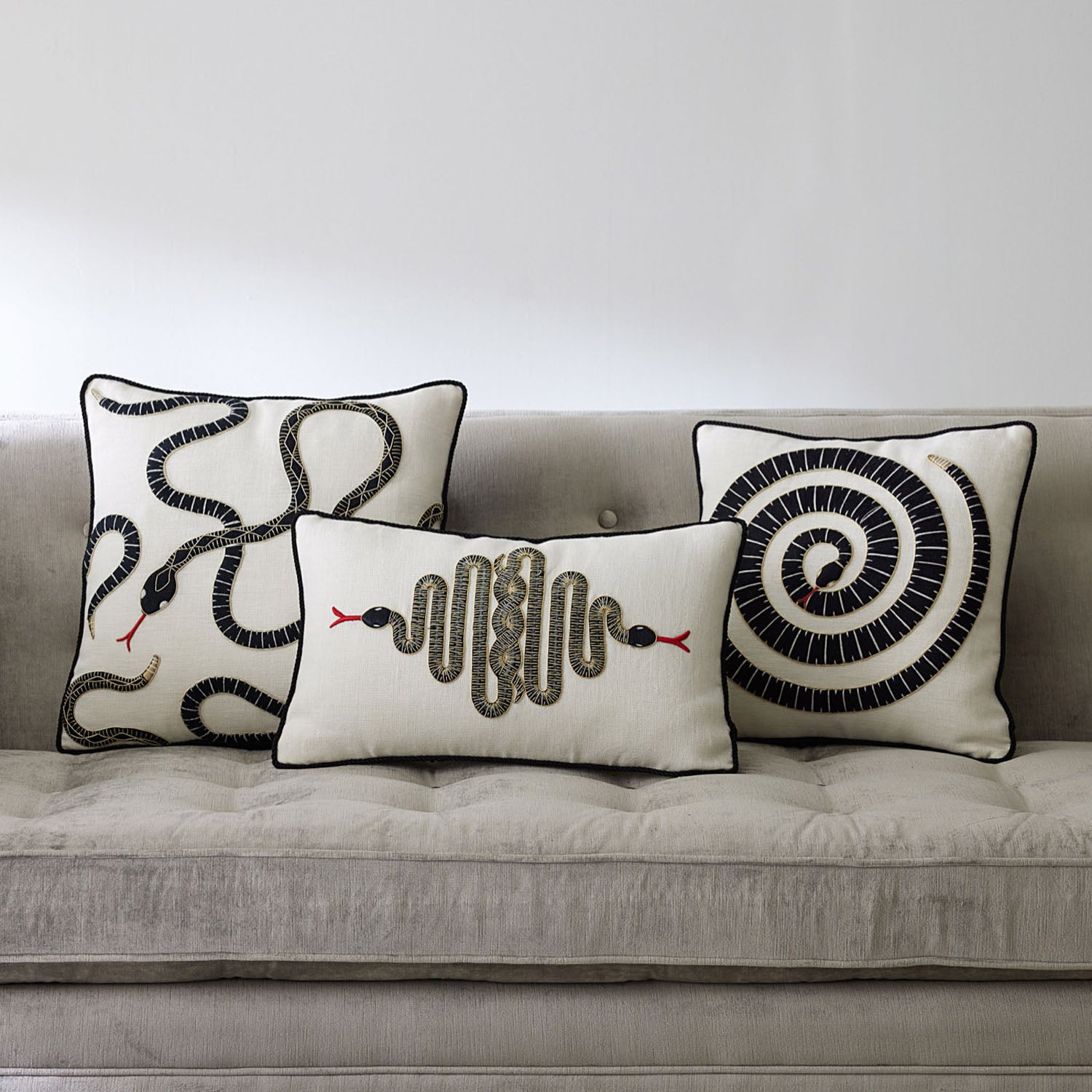 Jonathan Adler Snake Embroidered Throw Pillow in black and ivory on linen styled in a room