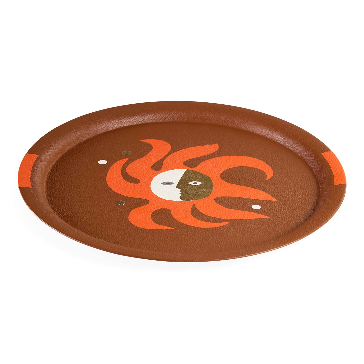 Detail of sun icon on round Playa leather tray