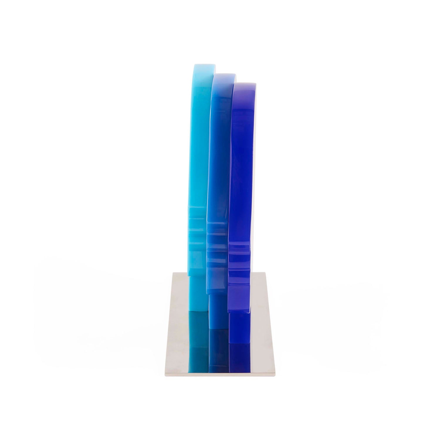 Side profile of Jonathan Adler Atlas Objet in layered multi-blue acrylic on a nickel base