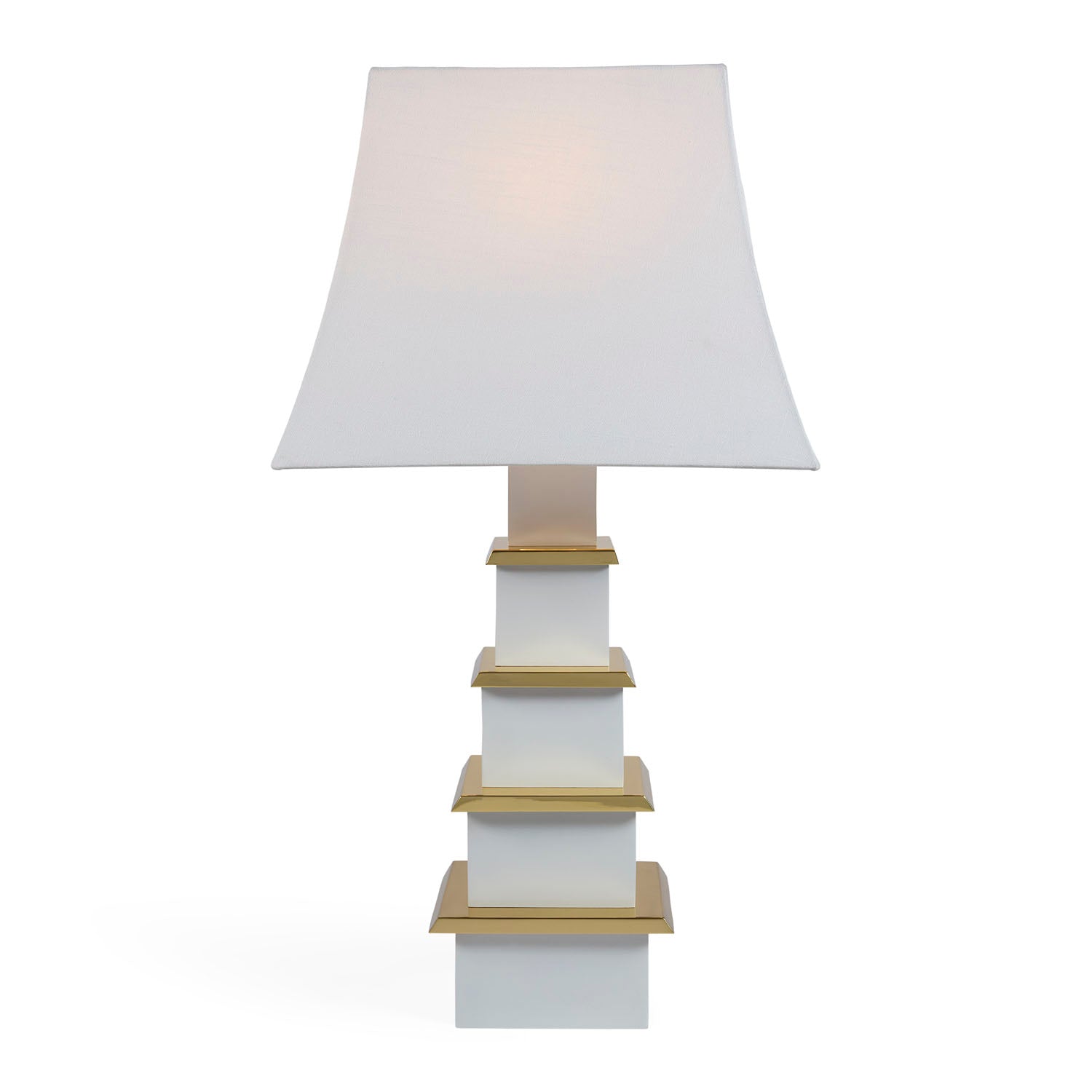 Jonathan Adler Pagoda ivory lamp illuminated on a console