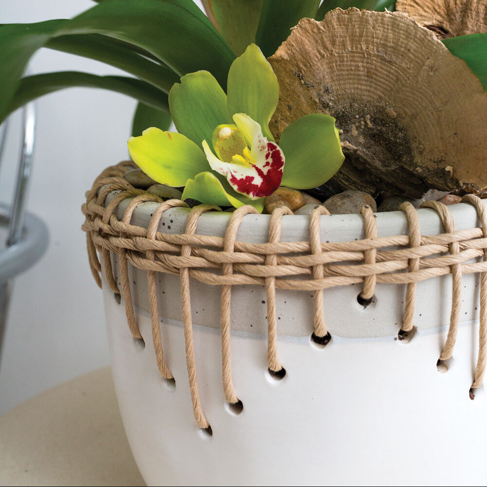Hideaway Pot styled view, two-tone ceramic rattan-trimmed planter