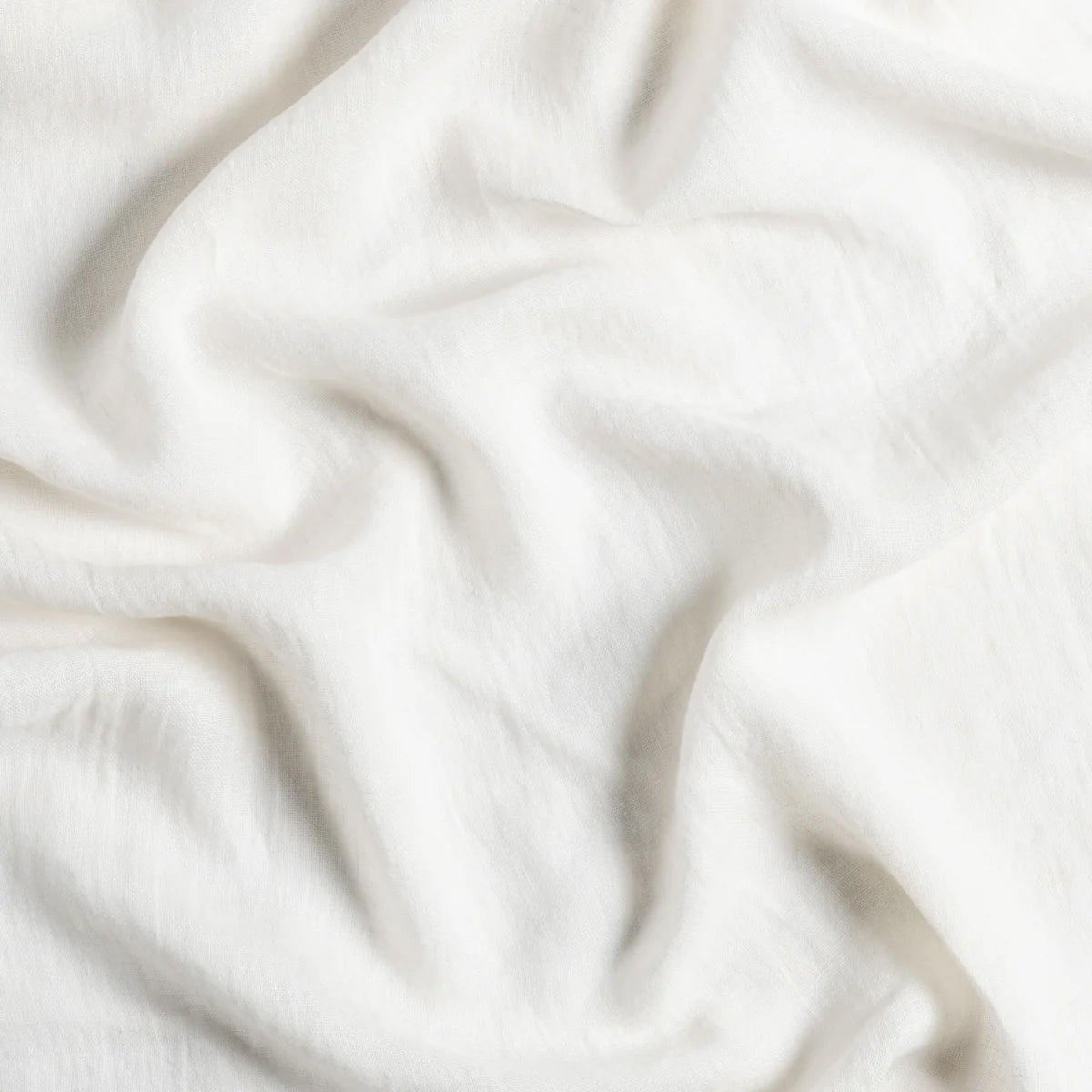 Bella Notte Linen Whisper Baby Blanket in linen whisper, shown from above in natural light