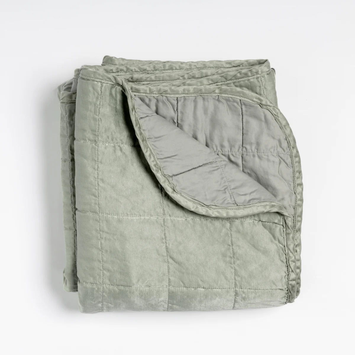 Bella Notte Sel Throw Blanket in quilted charmeuse, soft-focus lifestyle styling
