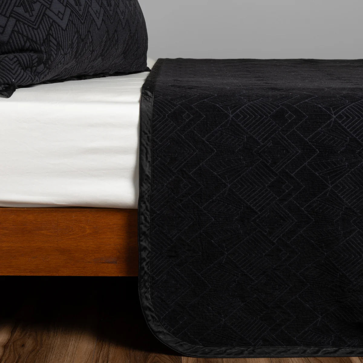 Bella Notte Trettino Bedspread in chenille jacquard, shown at an angle to reveal the sheen