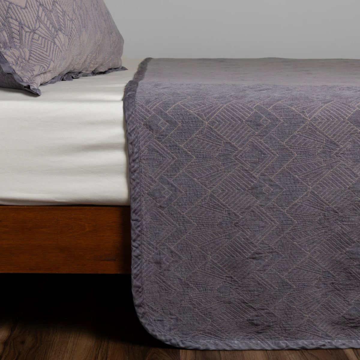 Bella Notte Trettino Bedspread in chenille jacquard, shown layered with coordinating bedding