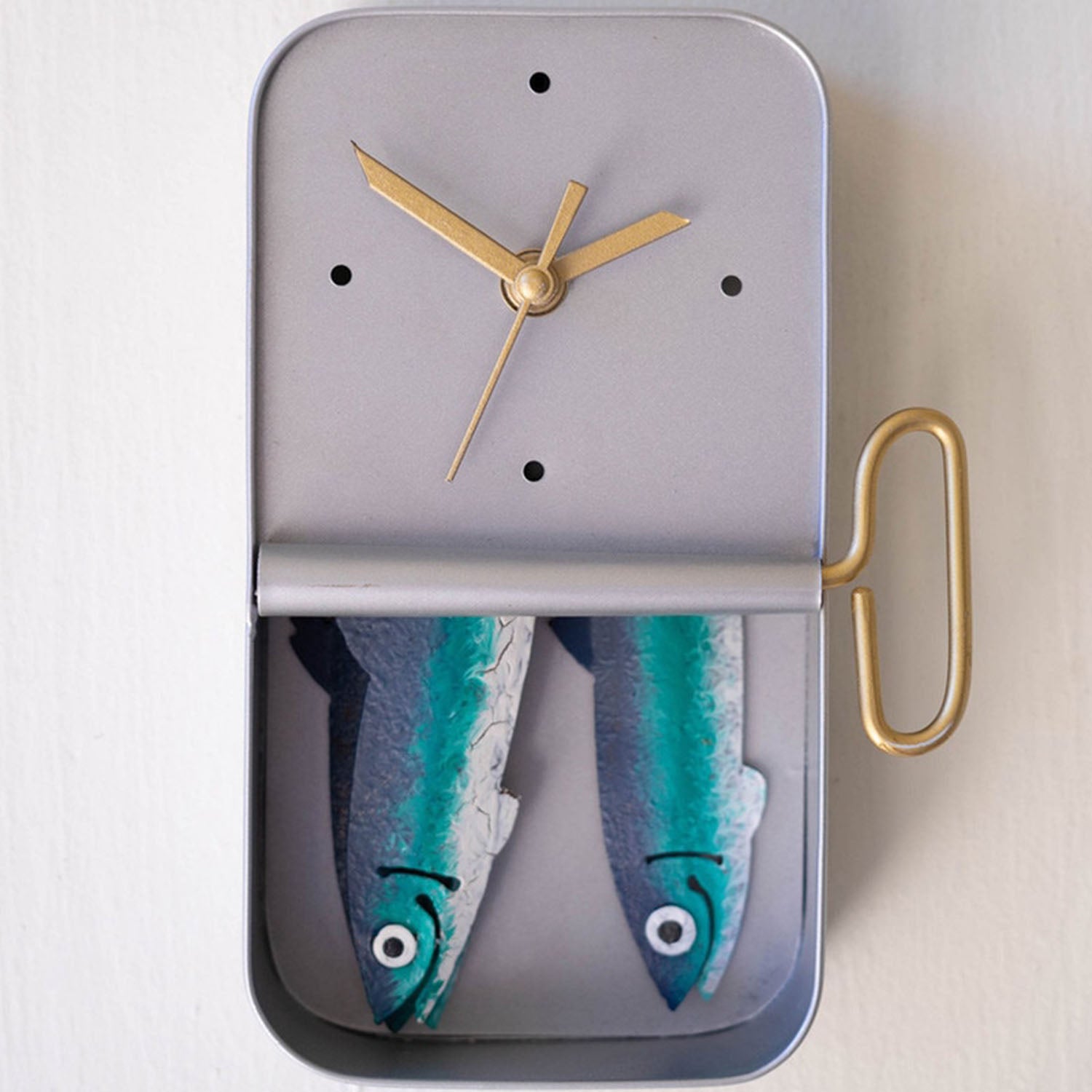 Close-up of little painted fish detail on the tin clock face