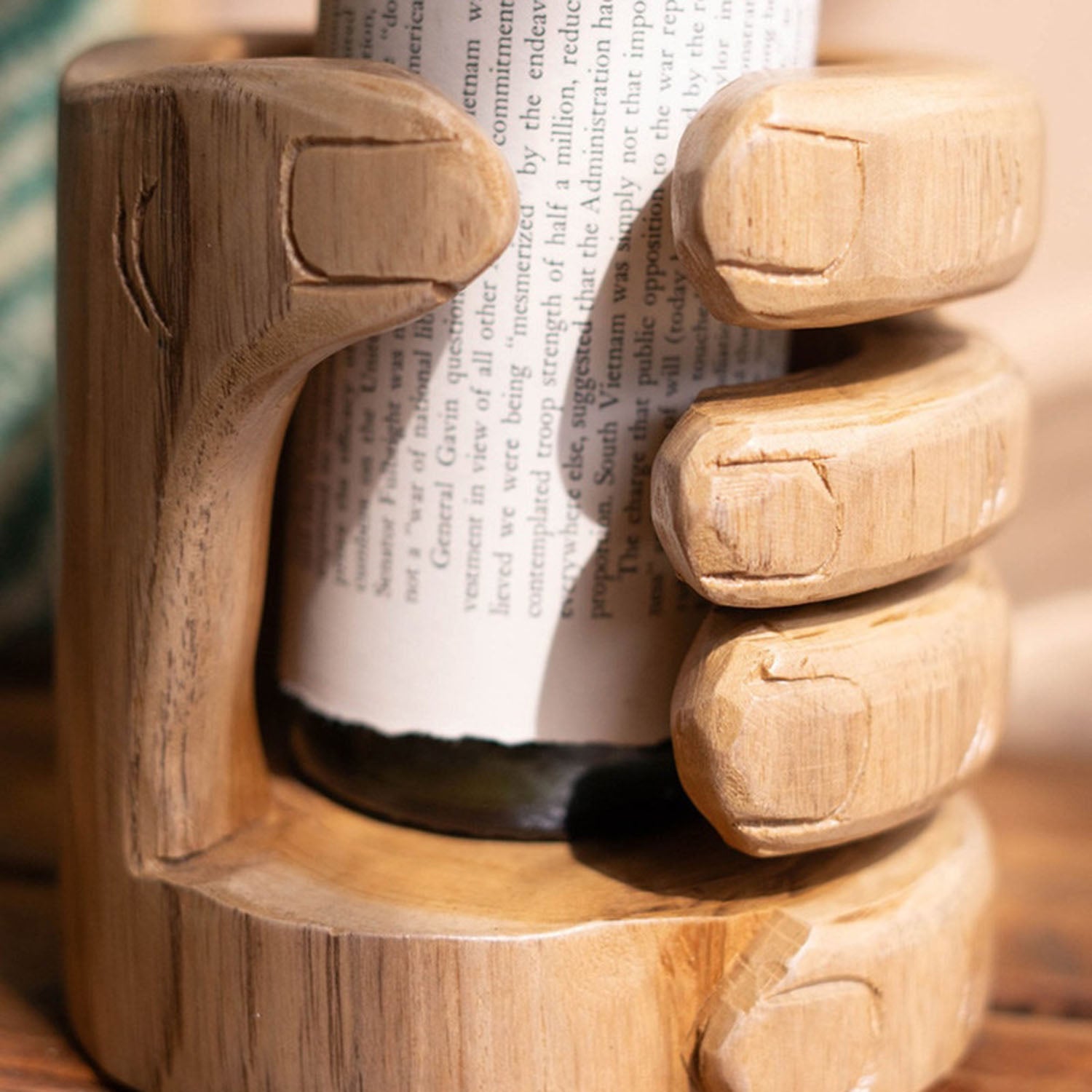 Teakwood hand wine holder styled on a bar cart with a bottle