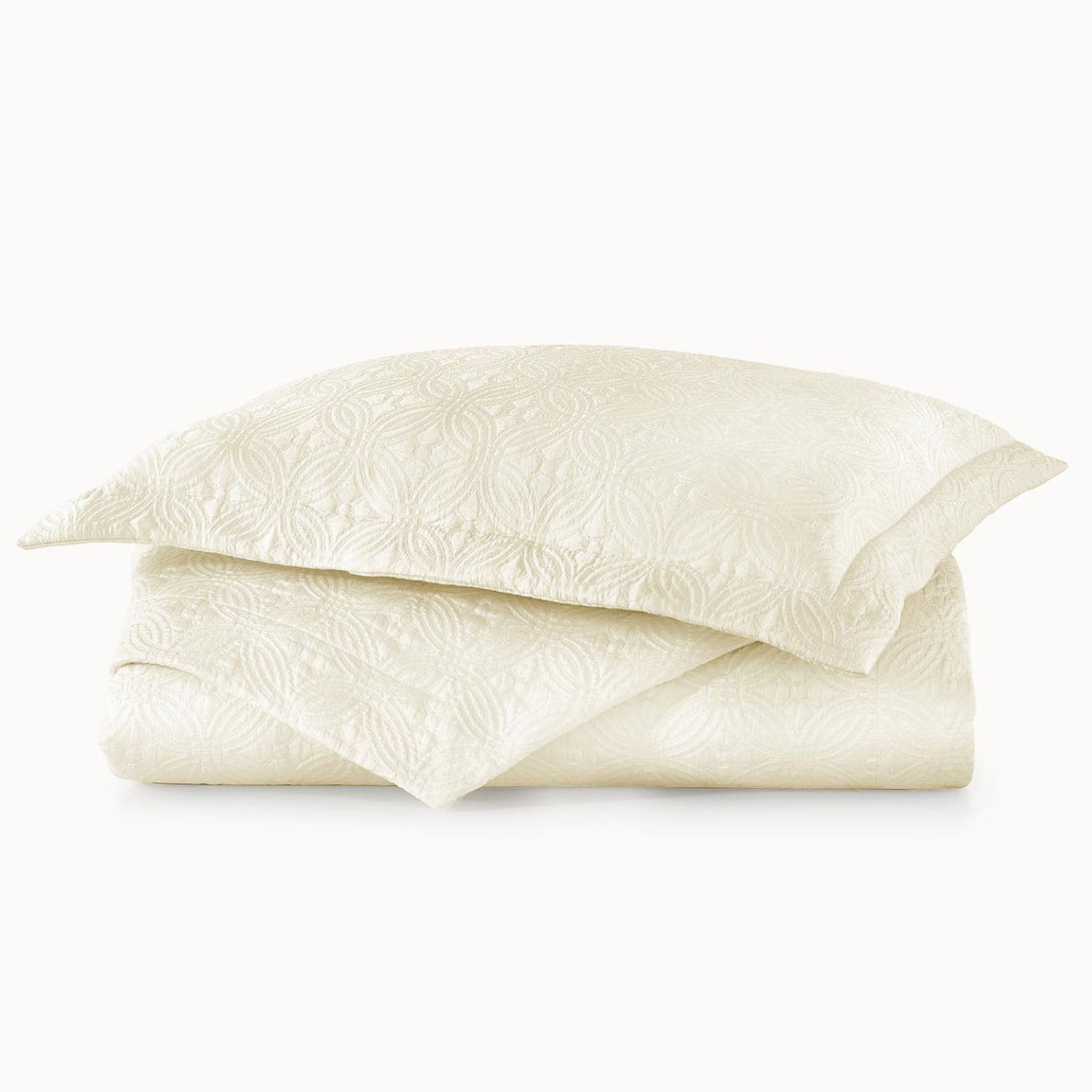 Peacock Alley Lucia matelasse cotton-silk coverlet stack of neatly folded linens